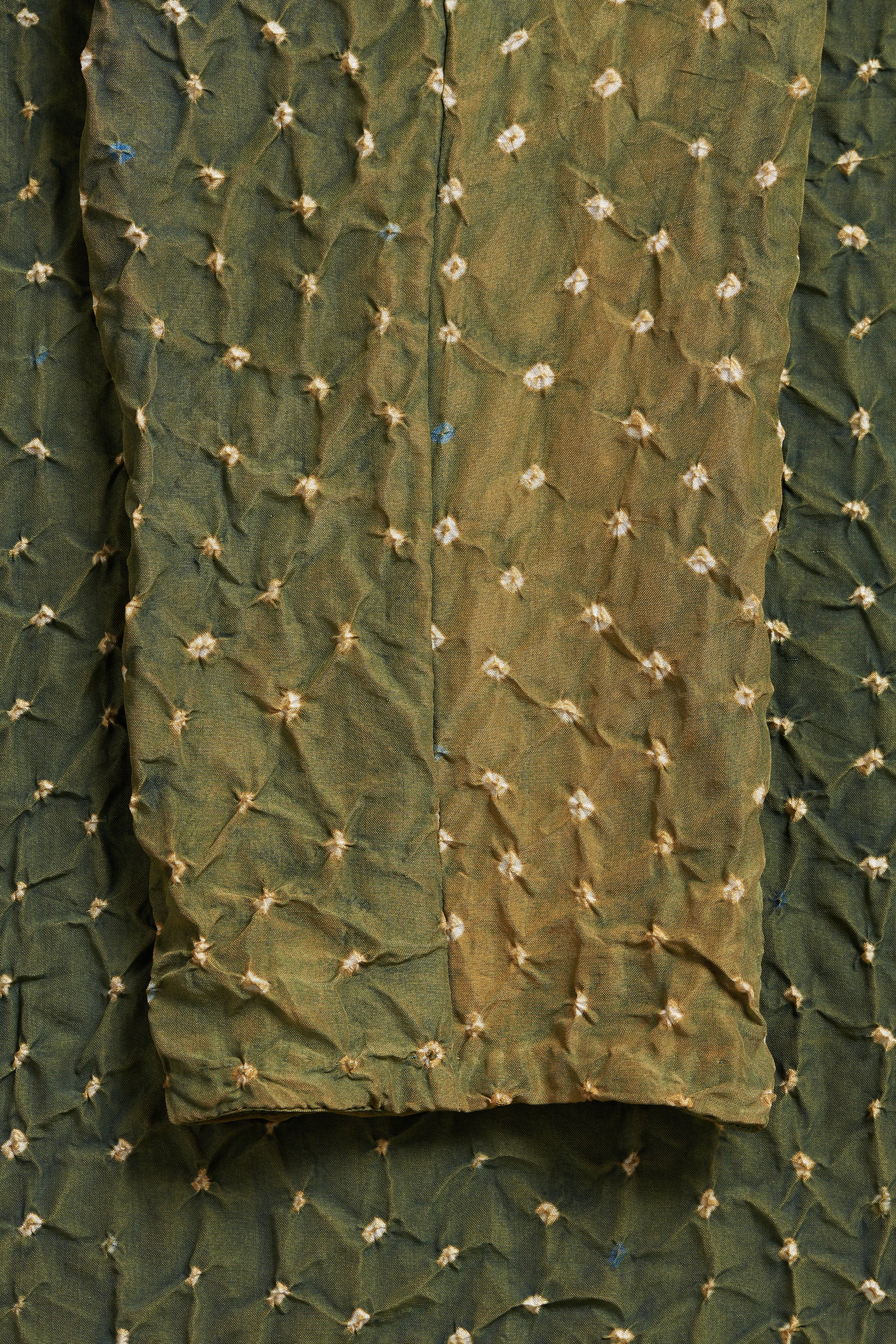 Green fabric with floral embroidery