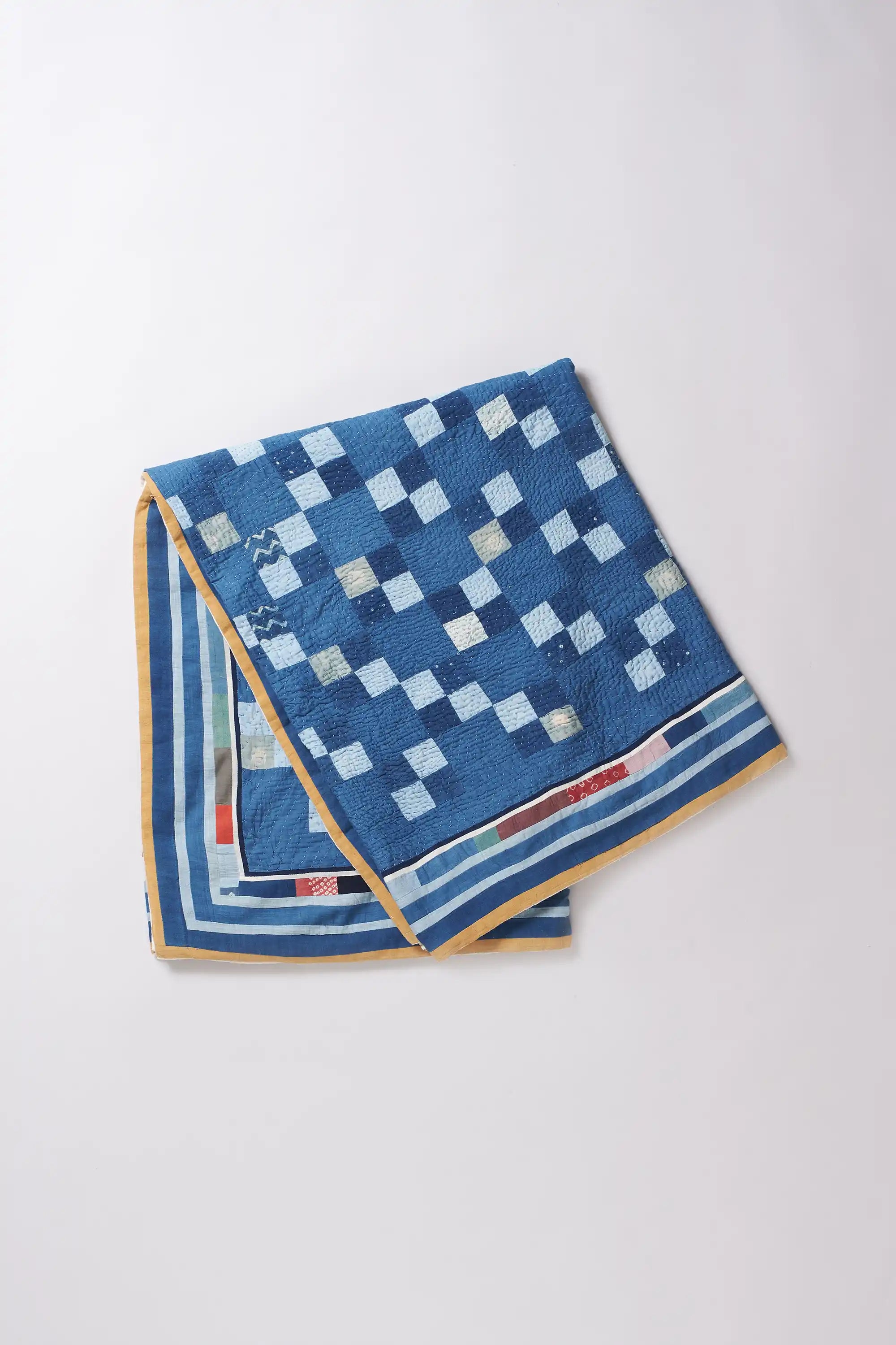 Blue checkered towel with yellow border on a white background