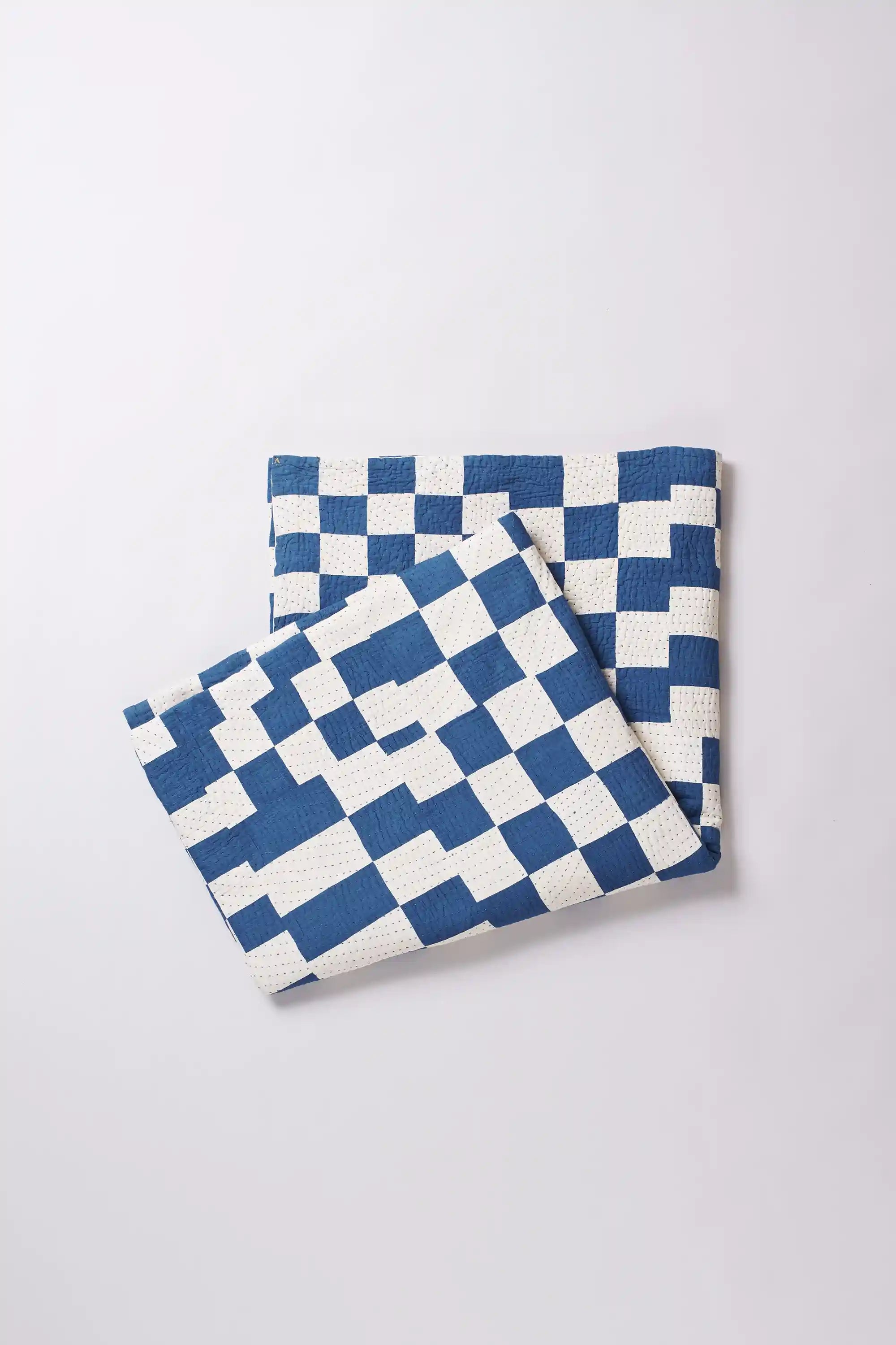 Two blue and white checkered towels on a light gray background