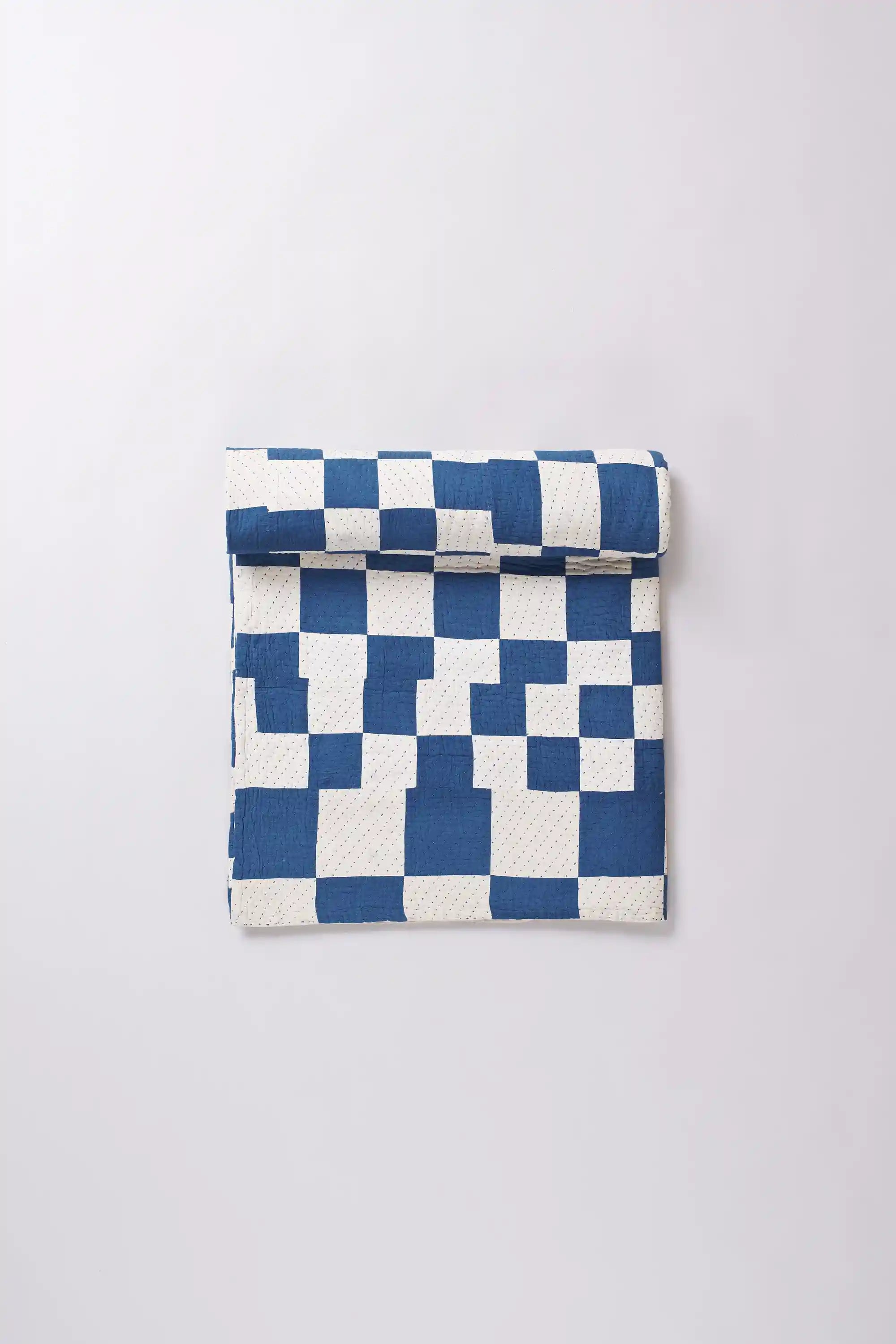 Checkered fabric pouch with blue and white pattern on a light gray background