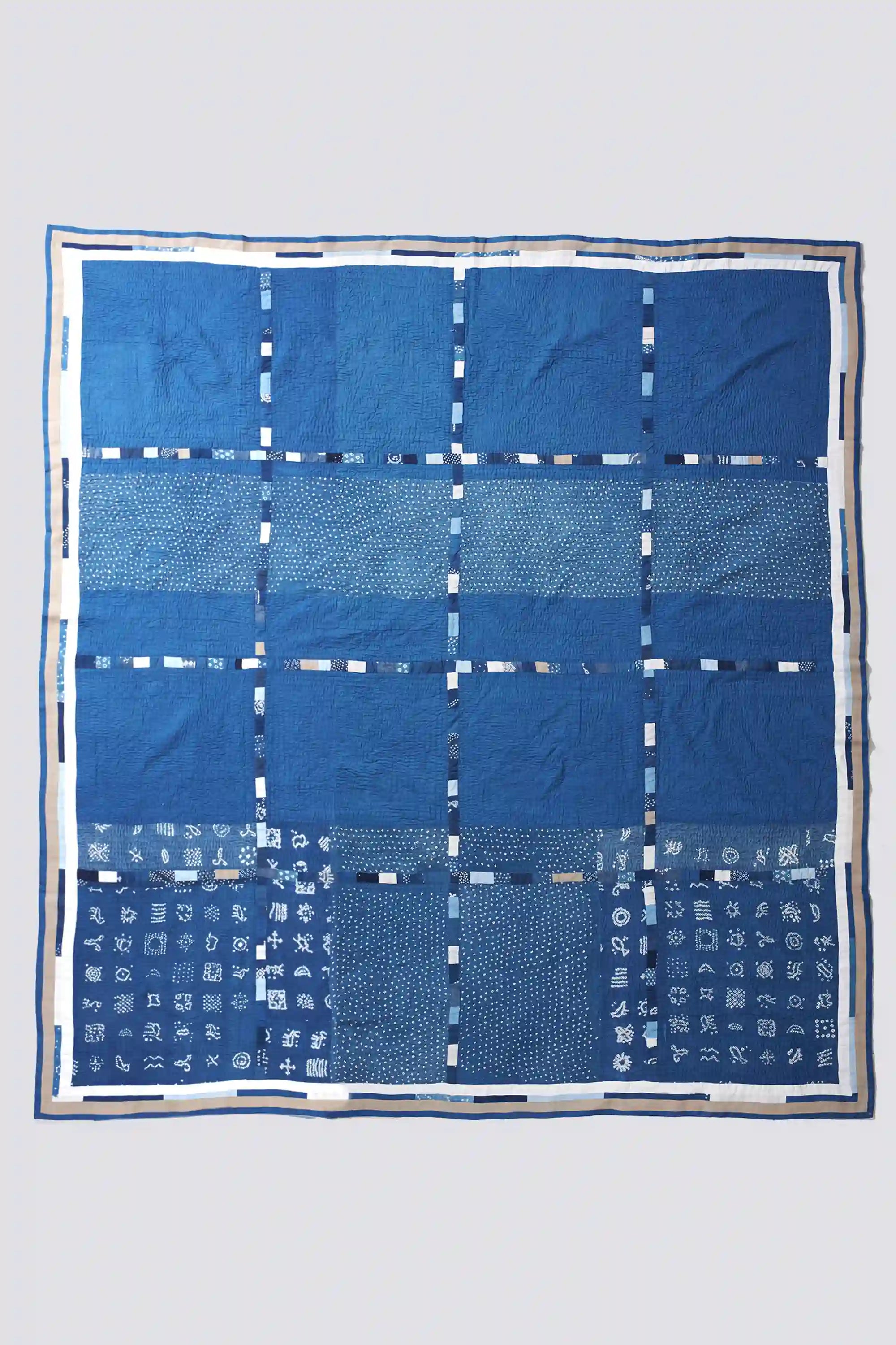 Blue fabric with white patterns on a light gray background