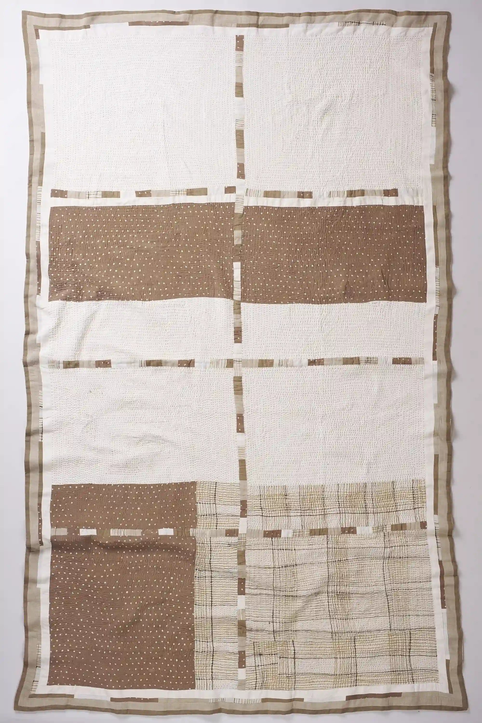 Patchwork quilt in smoke and tree trunk
