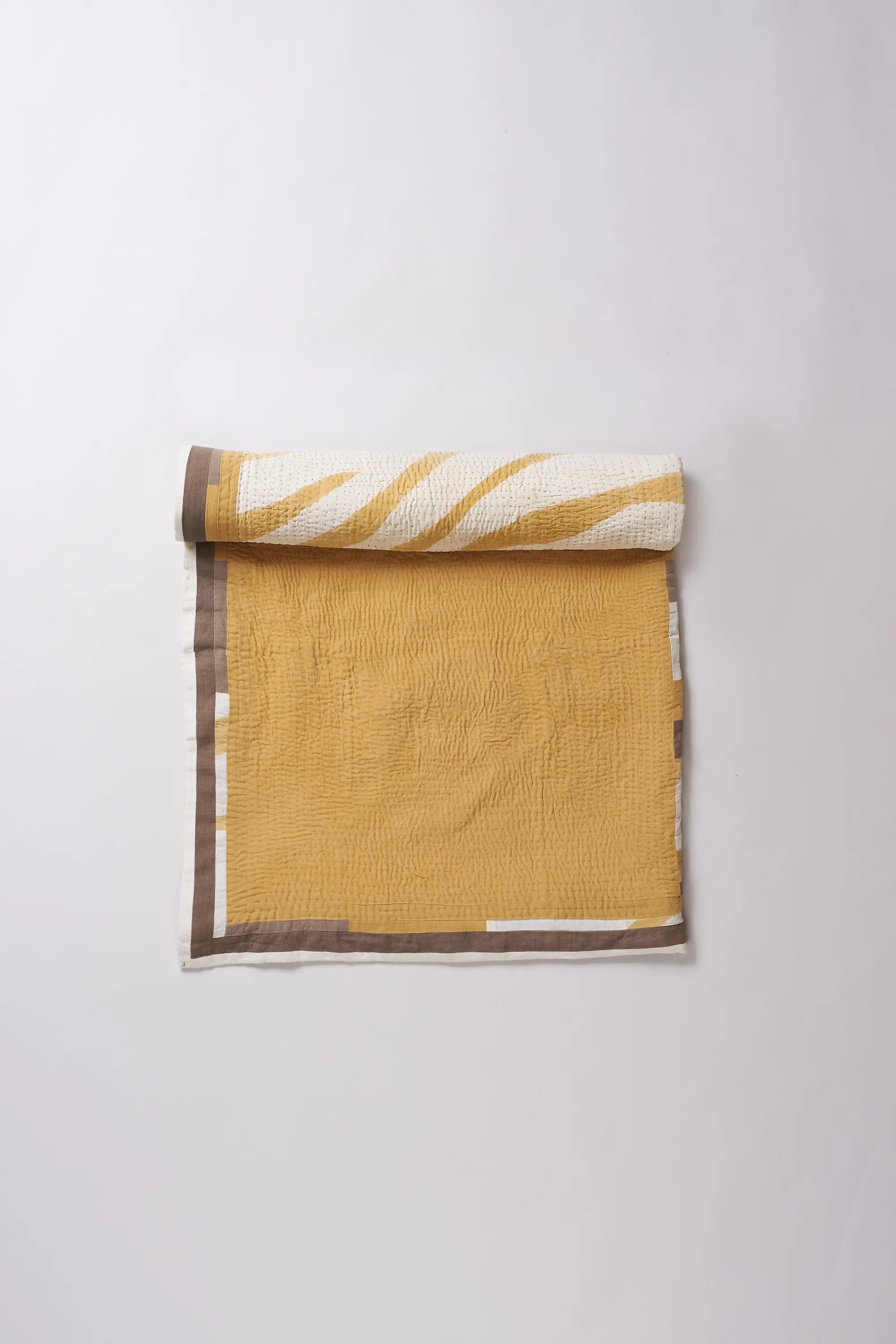 Colorful patterned fabric roll on a white background