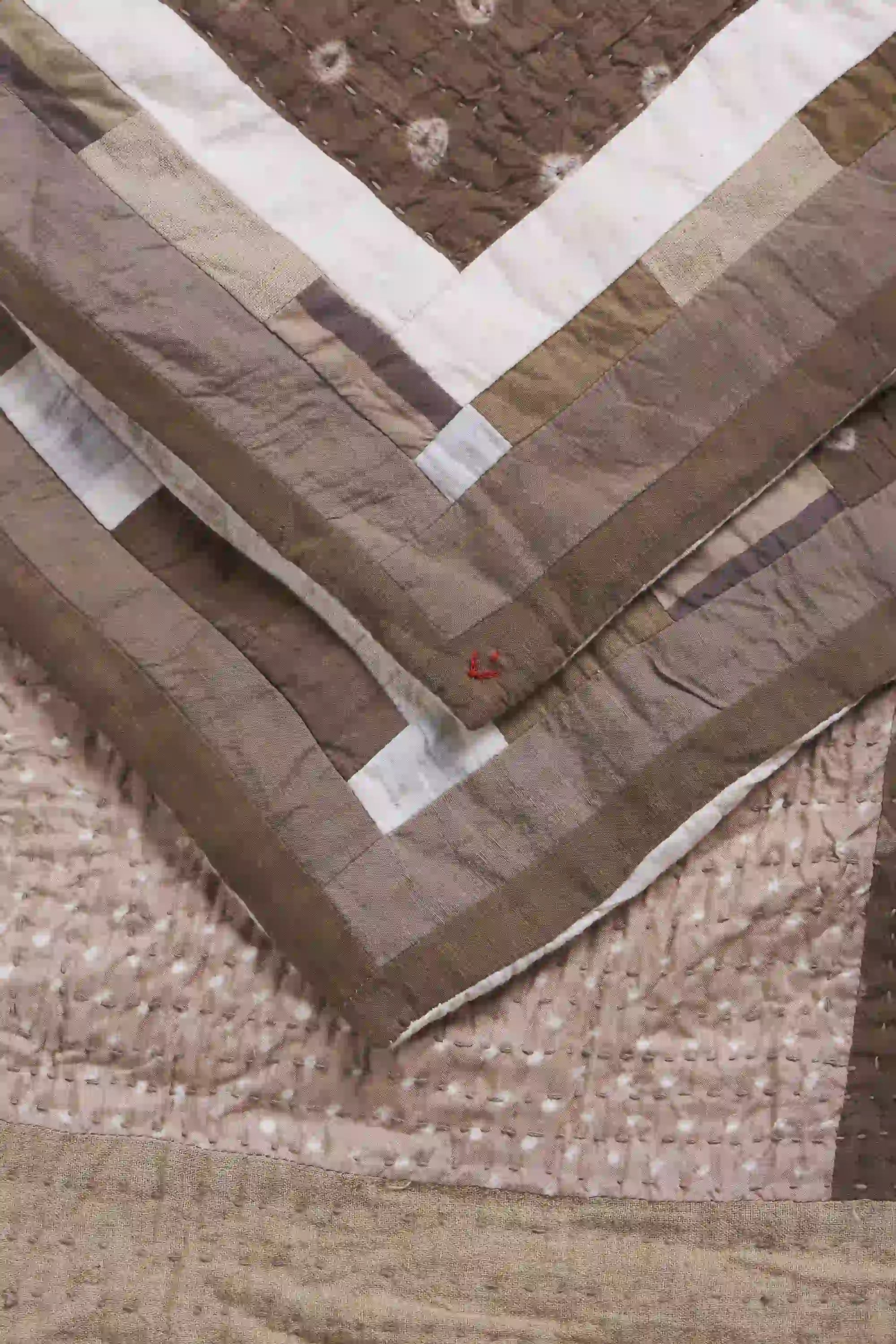 Close-up of a quilt with brown and beige patterns