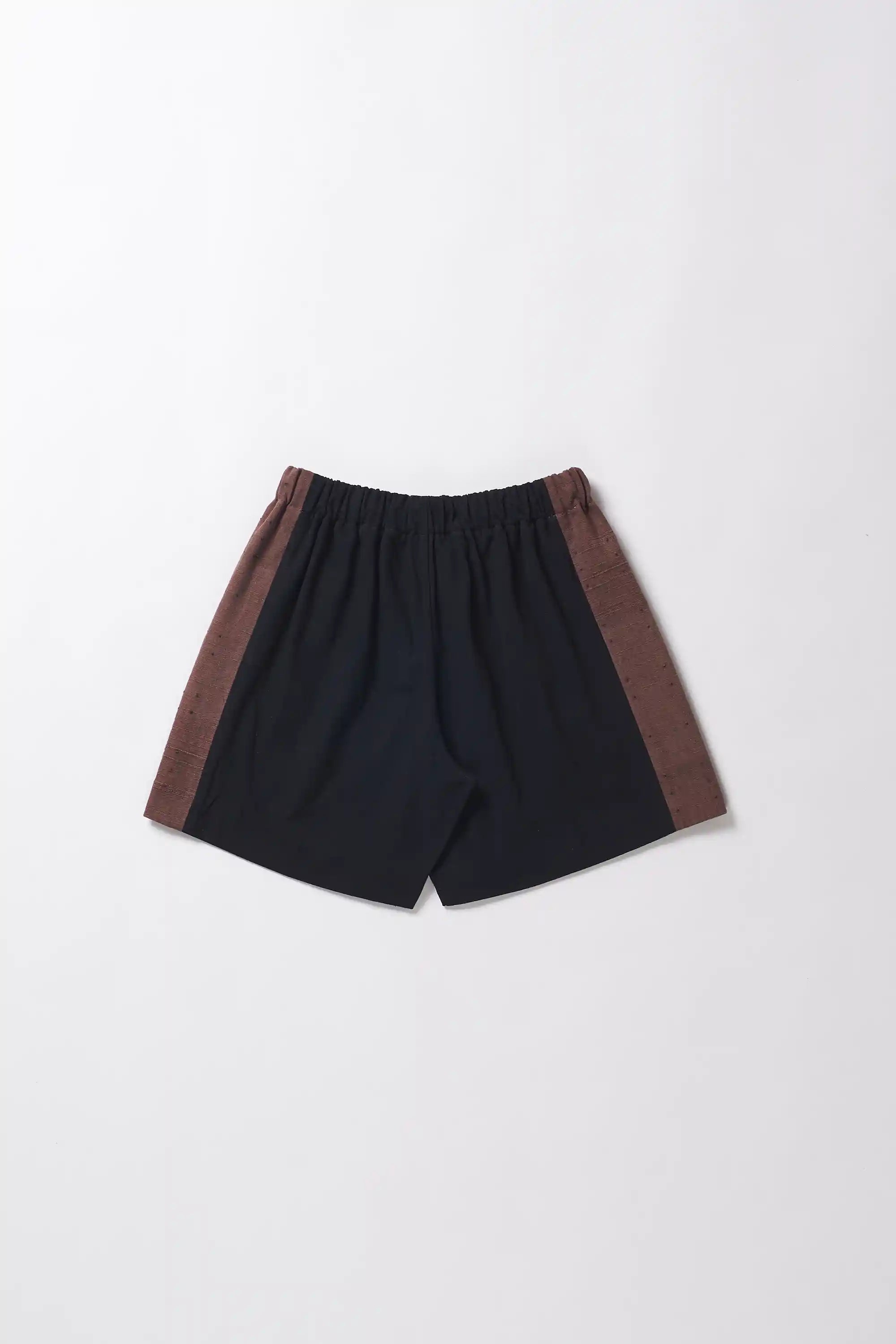 Black shorts with brown accents on a light grey background