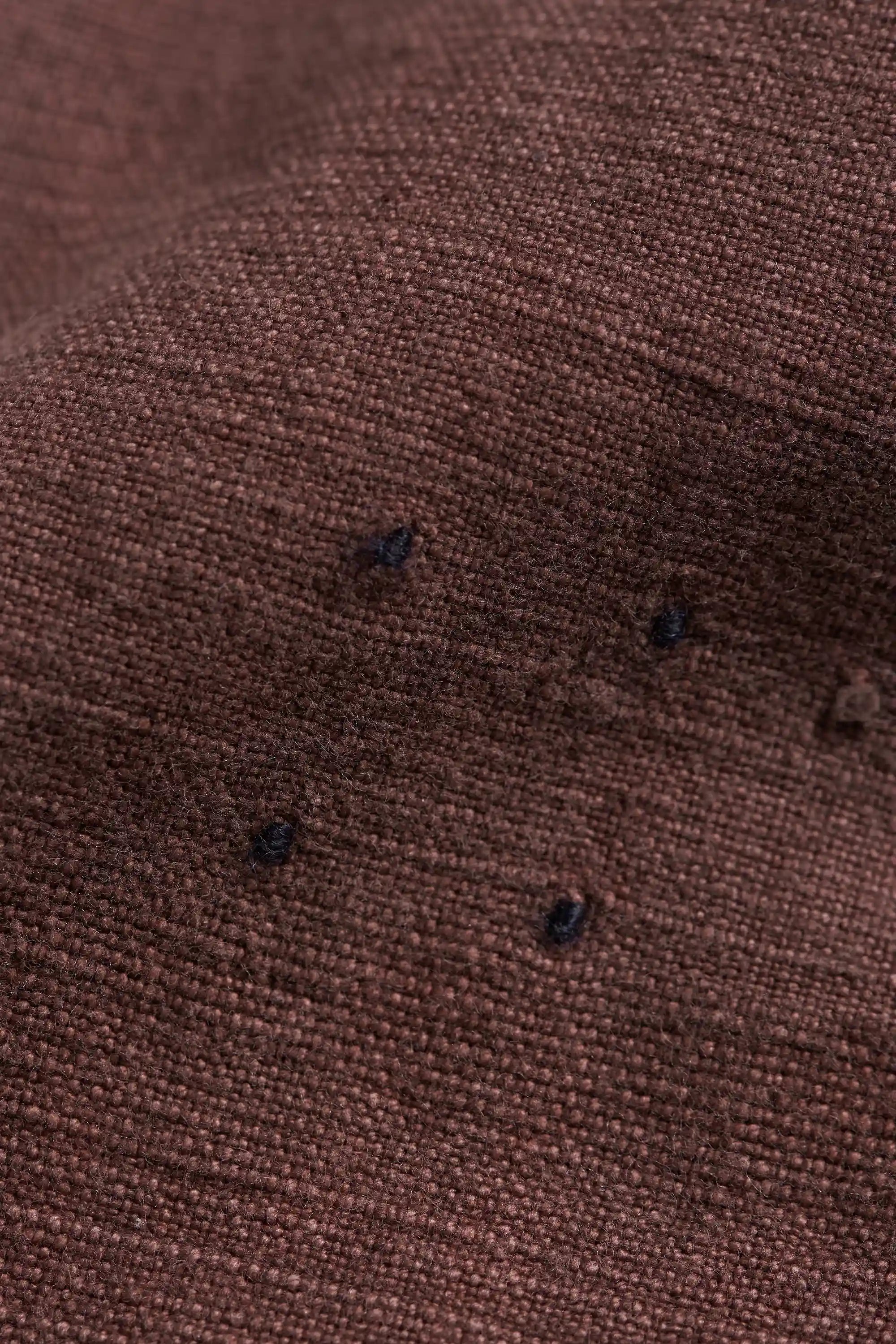 Close-up of brown fabric with tangliya work