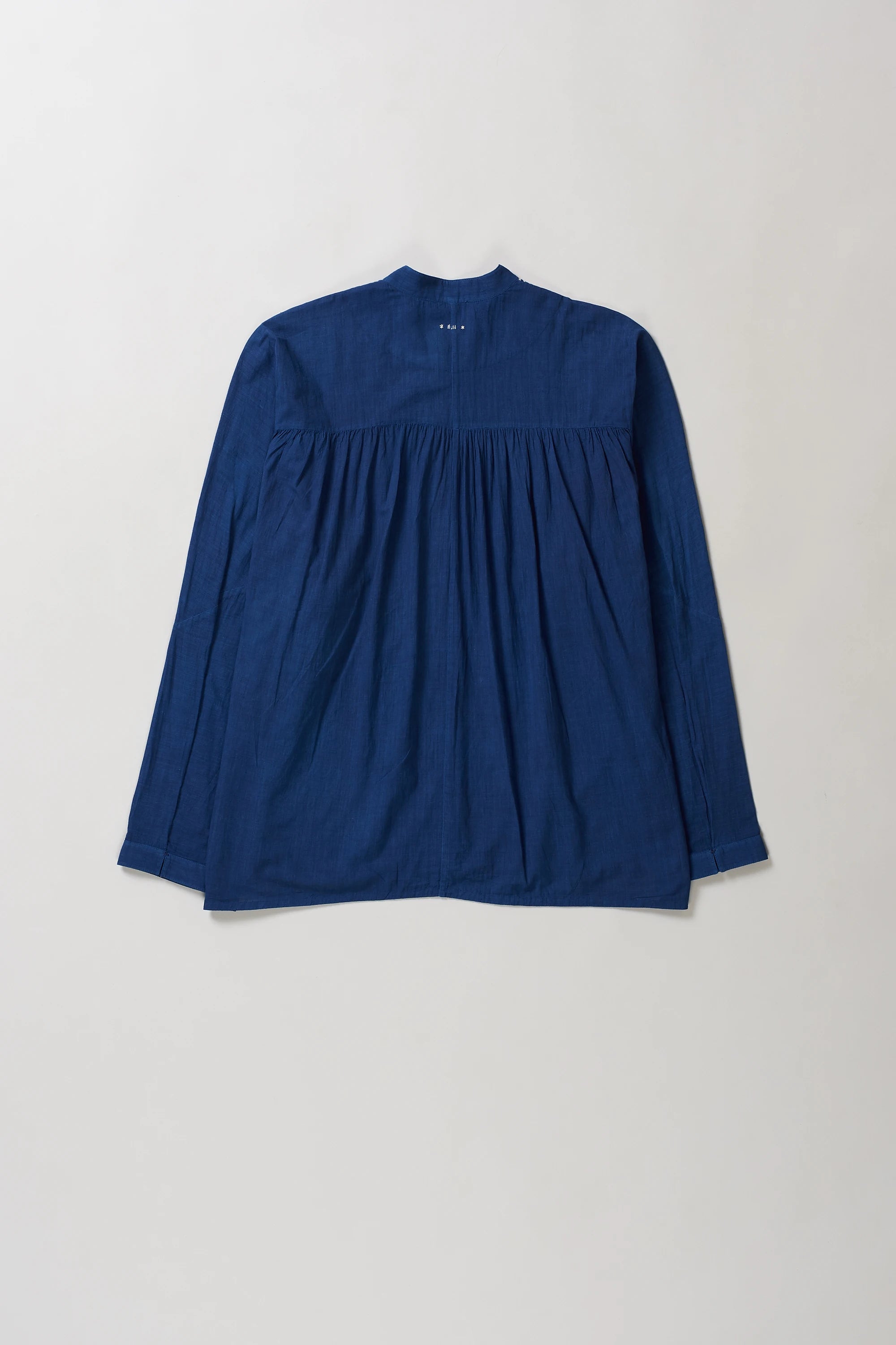 Blue long-sleeve shirt on a light grey background
