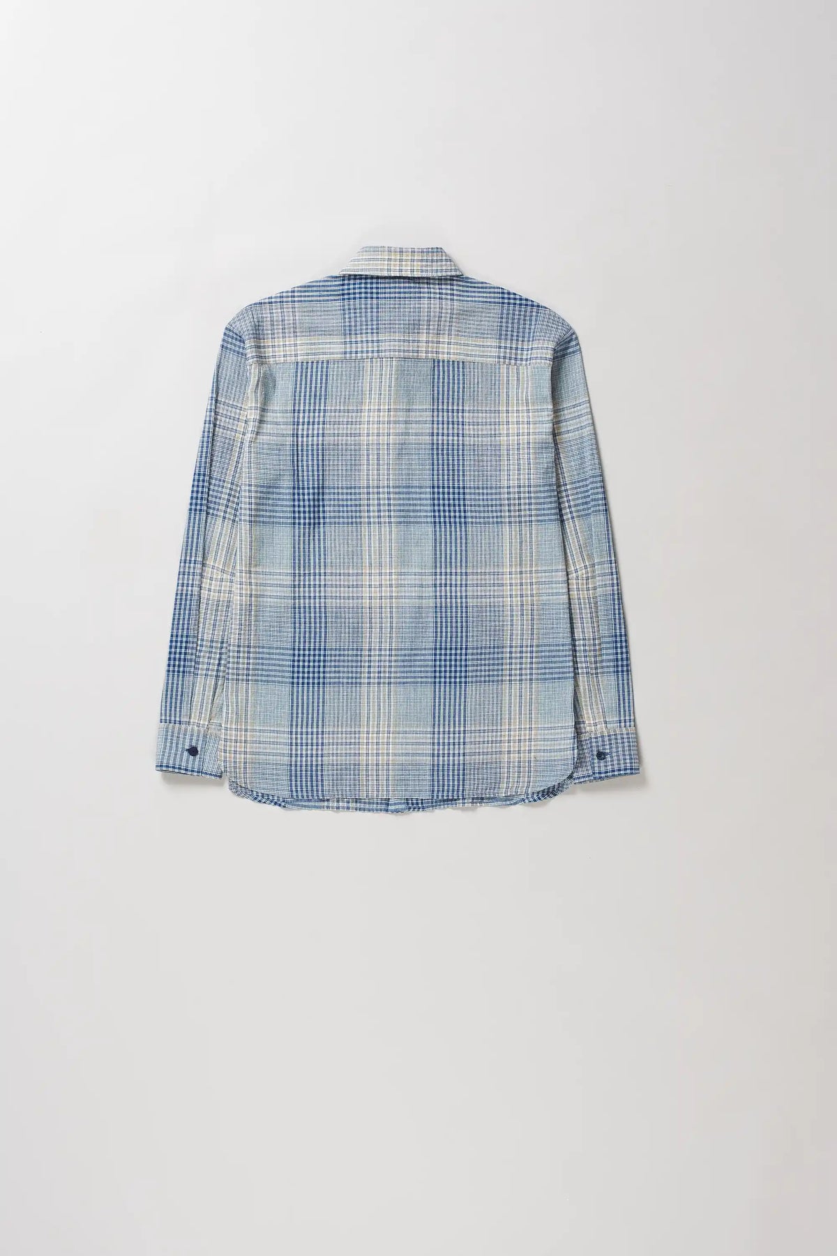 A long-sleeve plaid button-up shirt in shades of blue, white, and light grey, shown from the back against a plain light grey background.