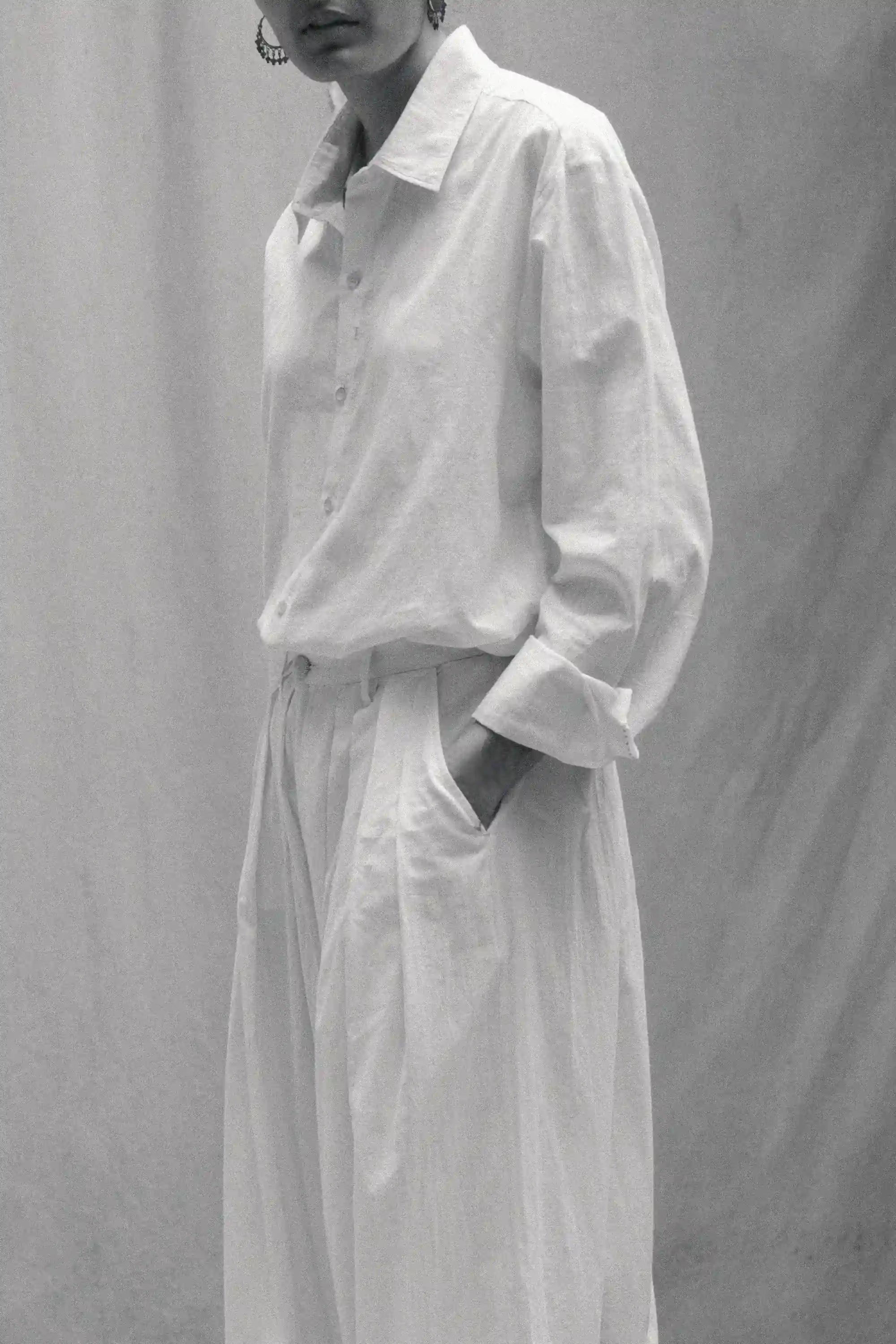 Side shot of a woman wearing ecru cotton shirt