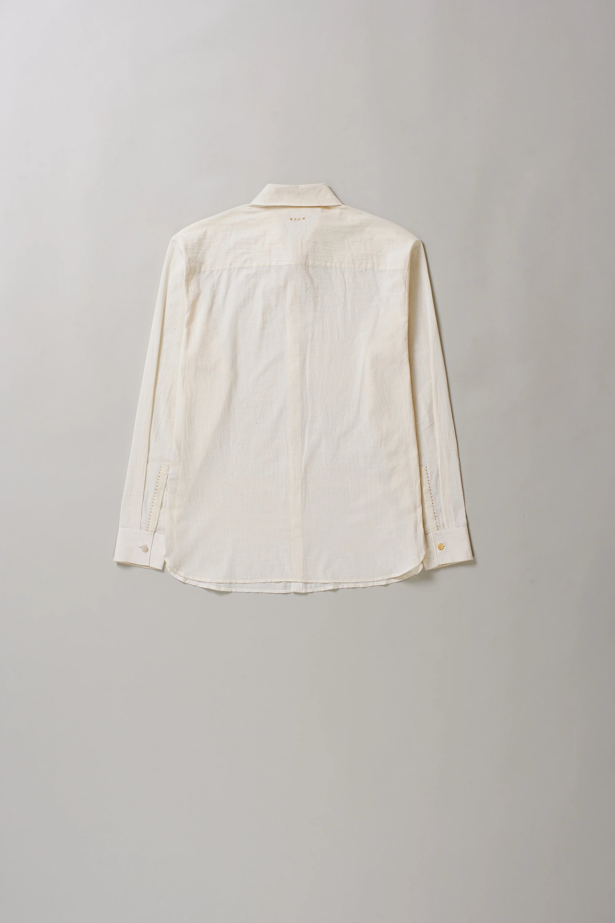 Back image of ecru cotton shirt on a grey background