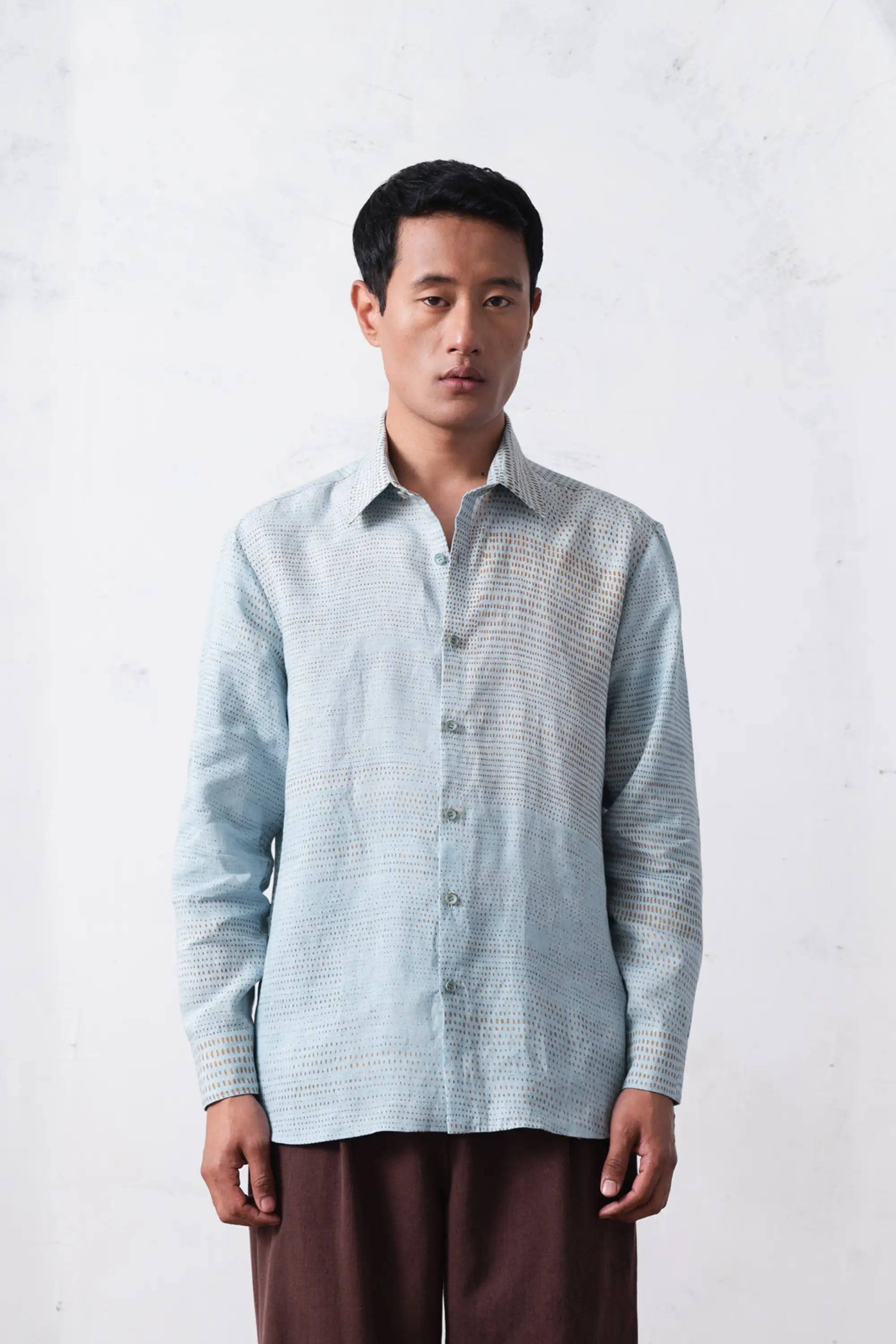 A man wearing sky indigo linen shirt