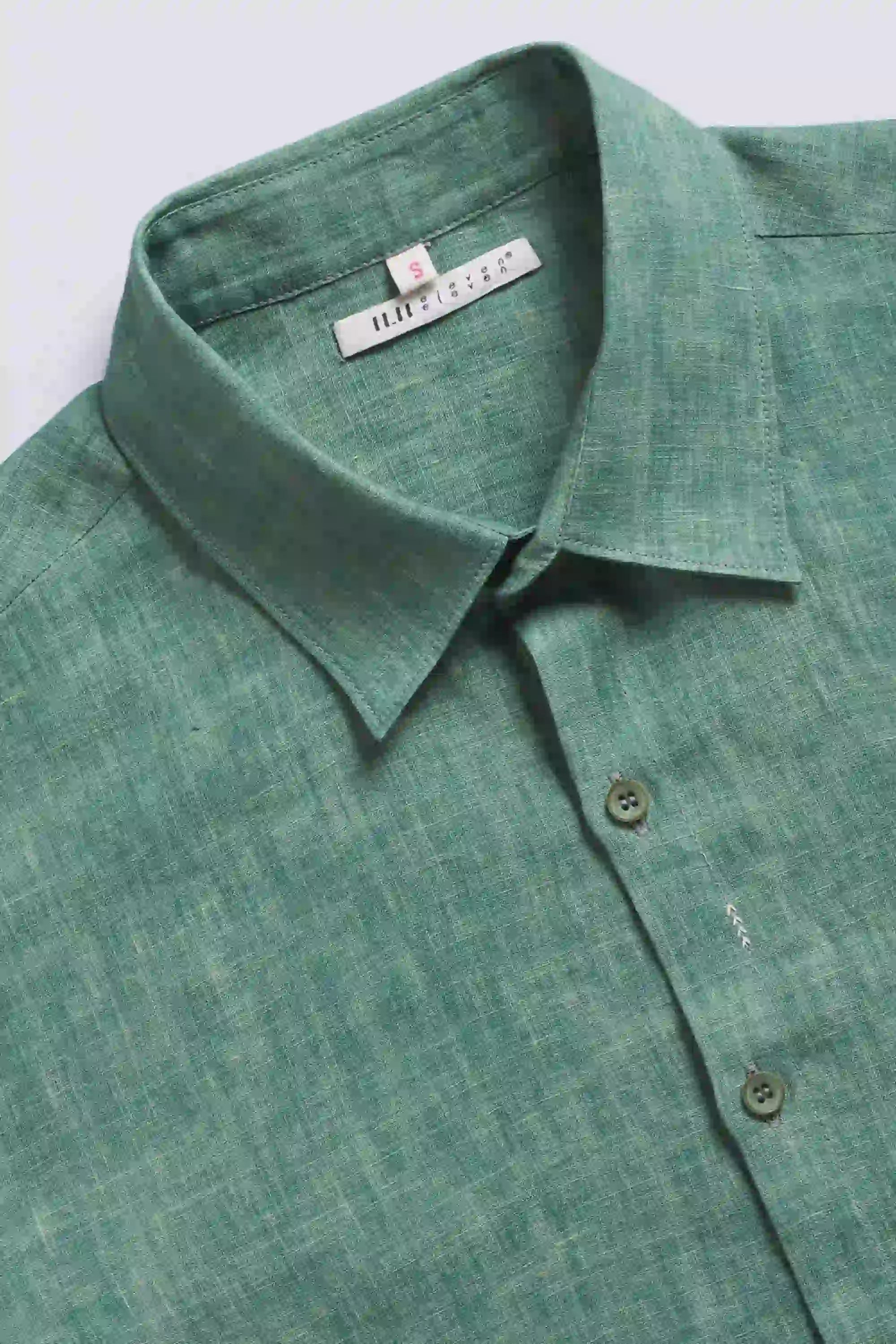 Close-up of turf green shirt with buttons and collar