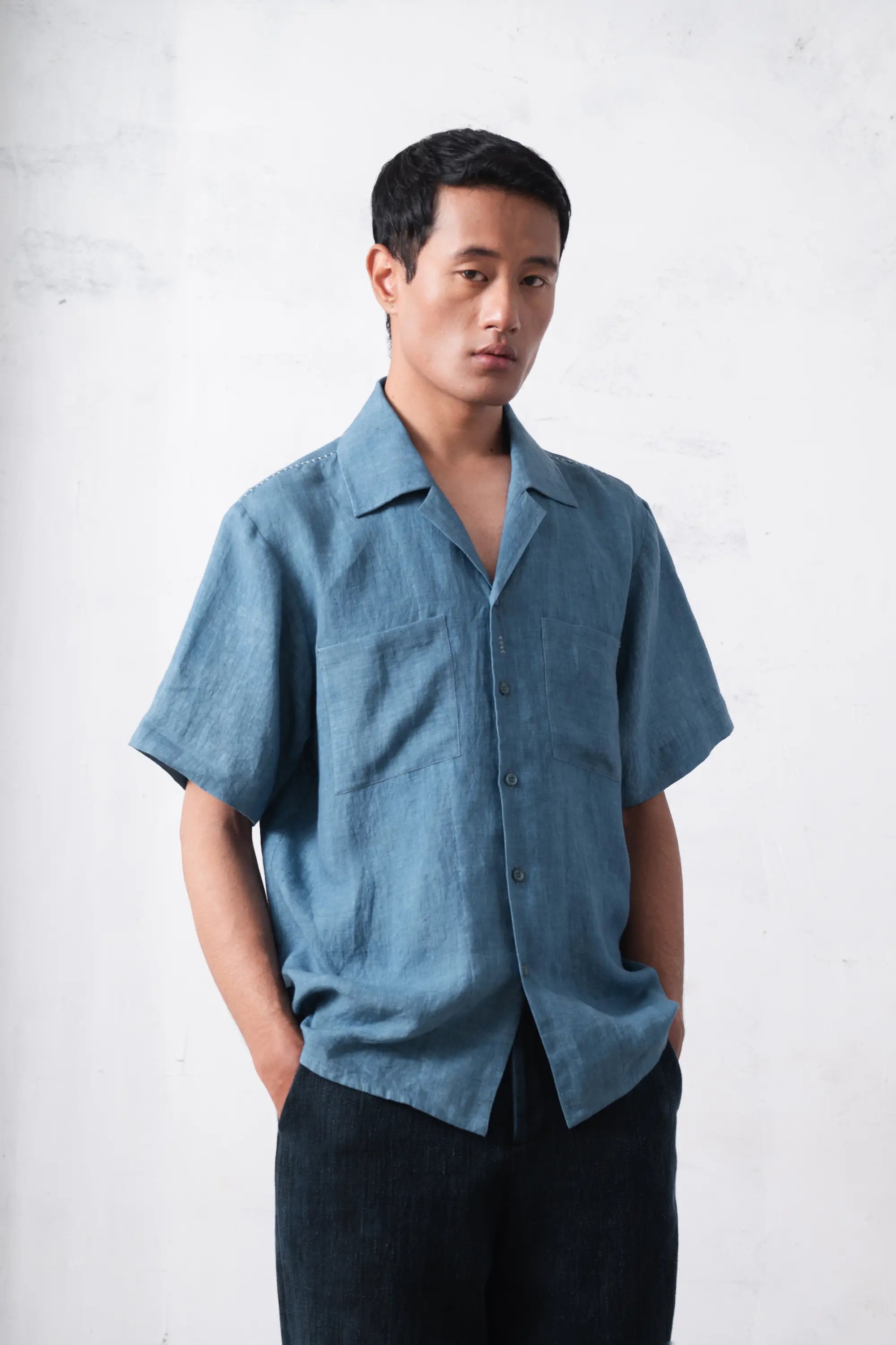 A man wearing powder blue linen shirt