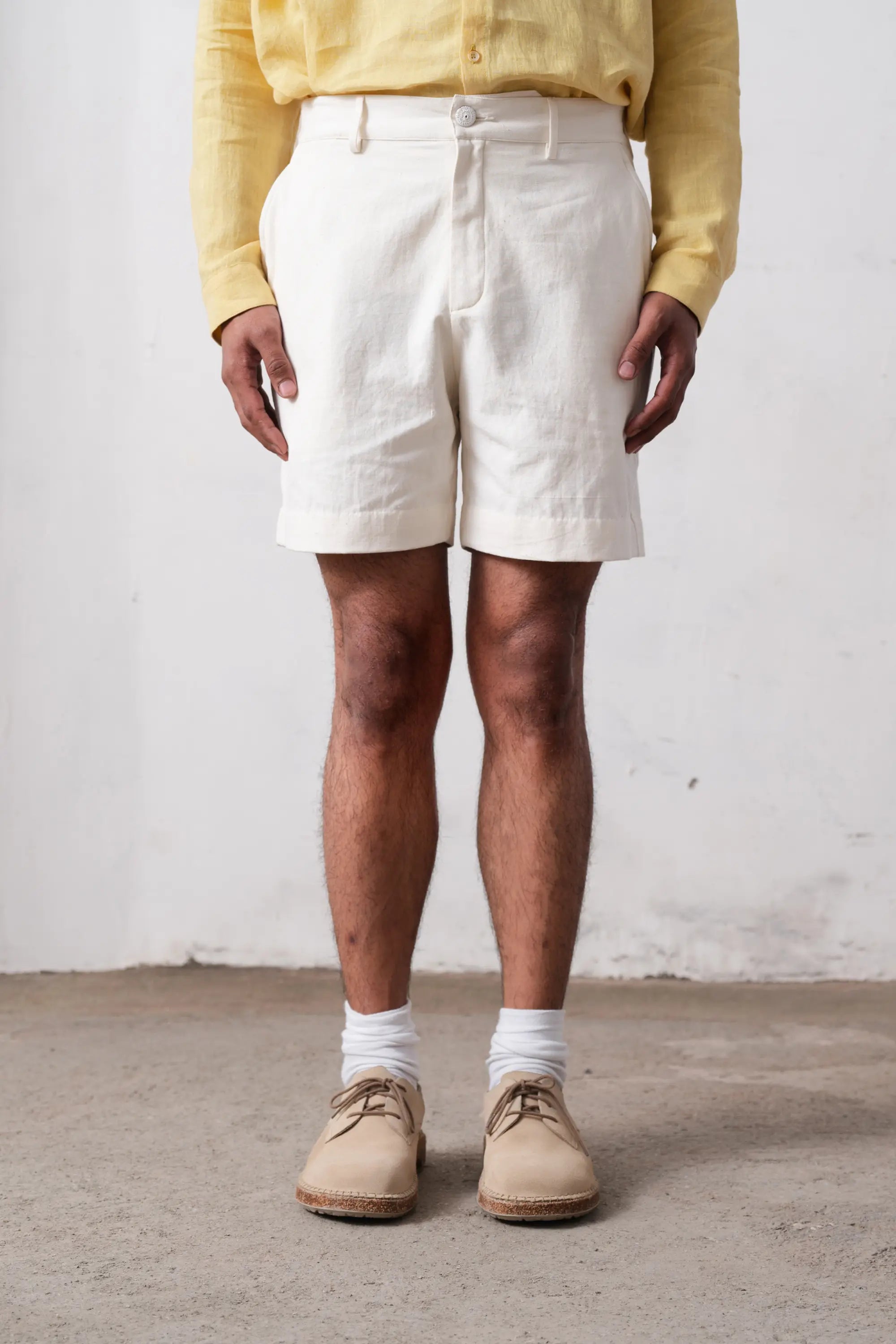 A man wearing ecru cotton shorts
