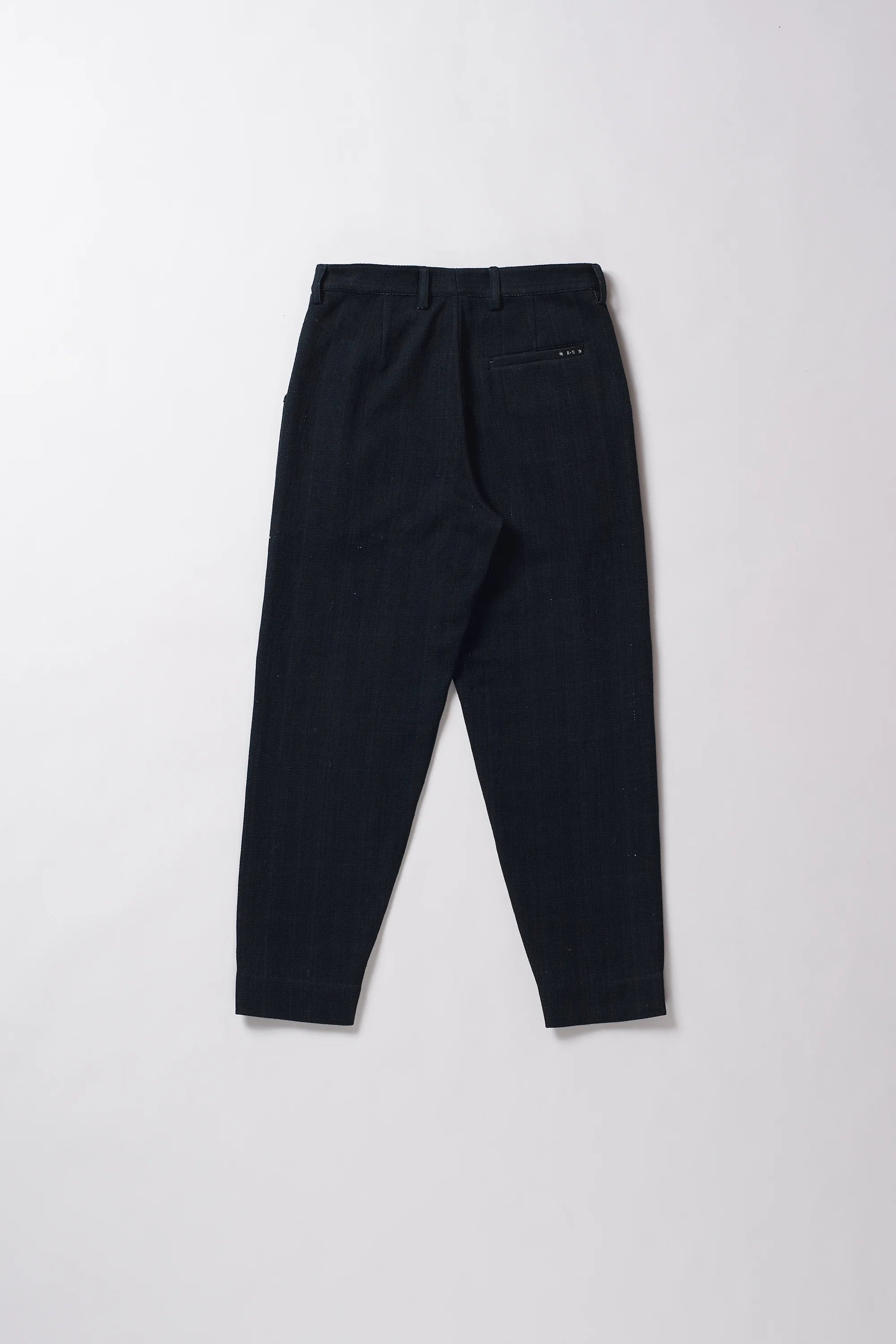 Black pants on a light grey background