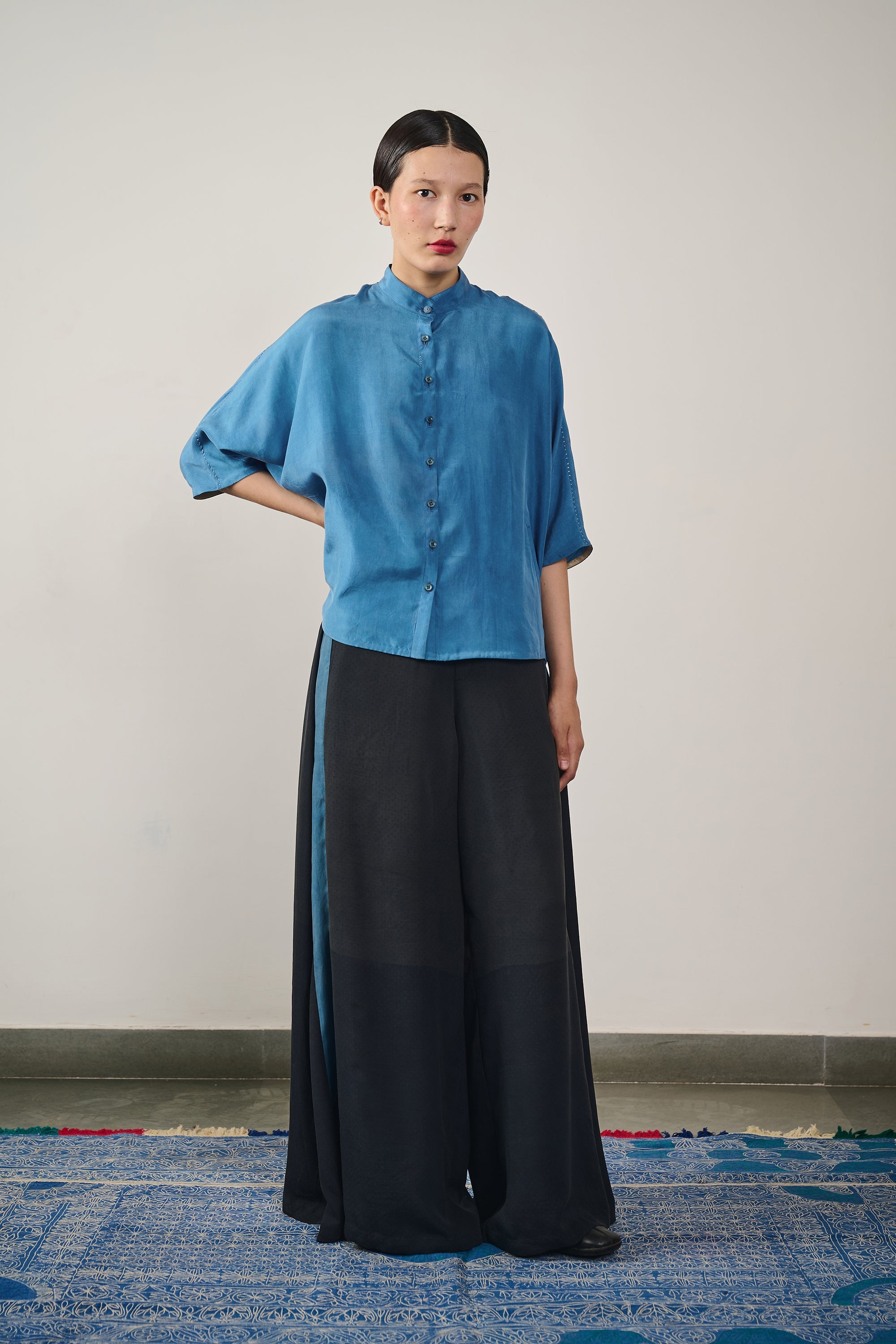 A woman wearing black trouser