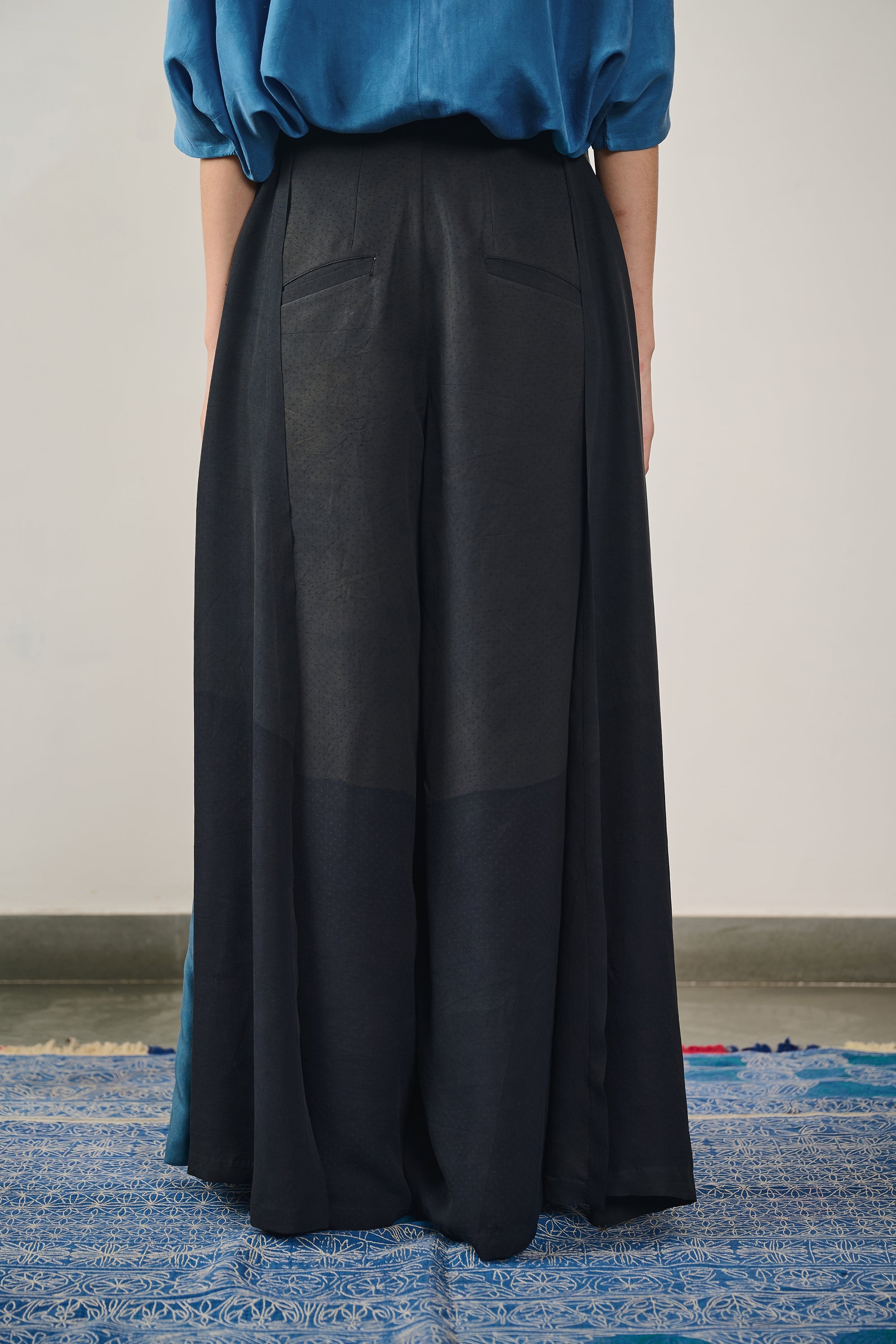 A woman wearing black trouser