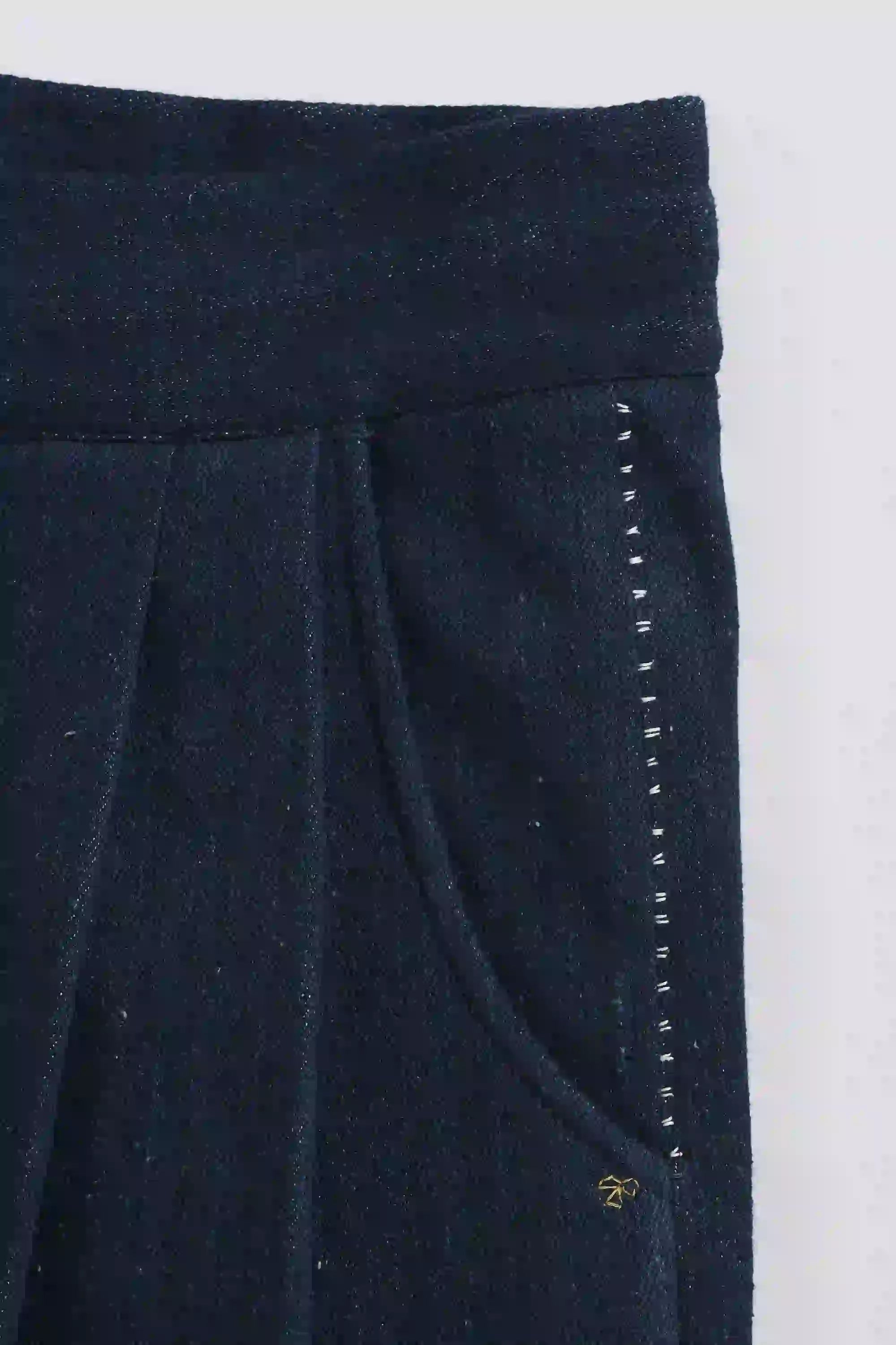 Close-up of dark blue fabric with a white border on a white background