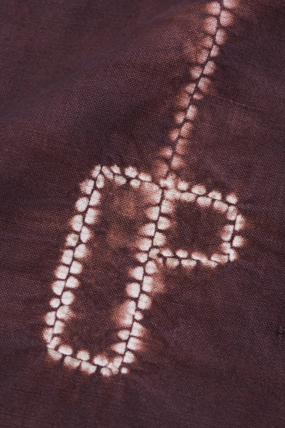 Close-up of a fabric with a white tie-dye or shibori.