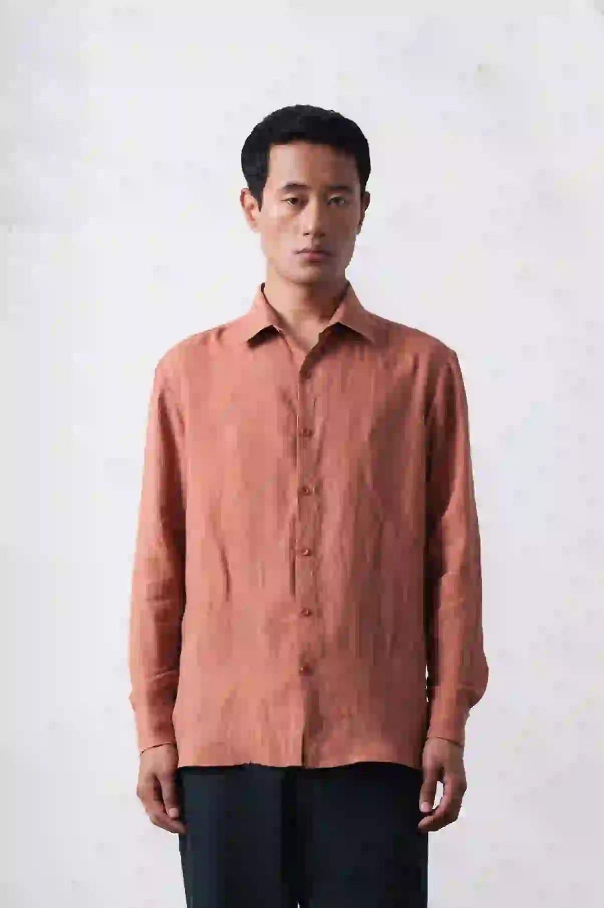 A man wearing orange rust shirt