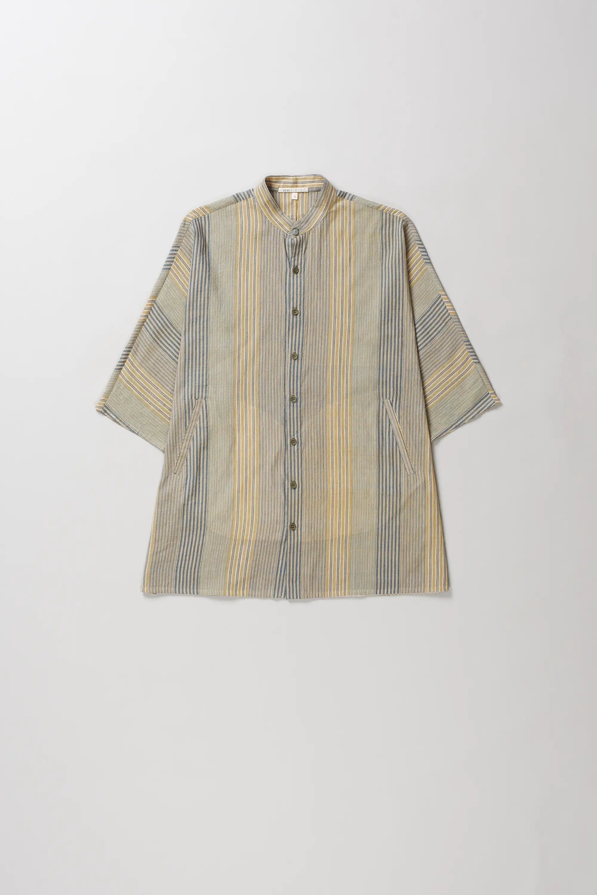 A short-sleeved button-up shirt with a vertical stripe pattern in beige, yellow, and gray, displayed flat against a light gray background.