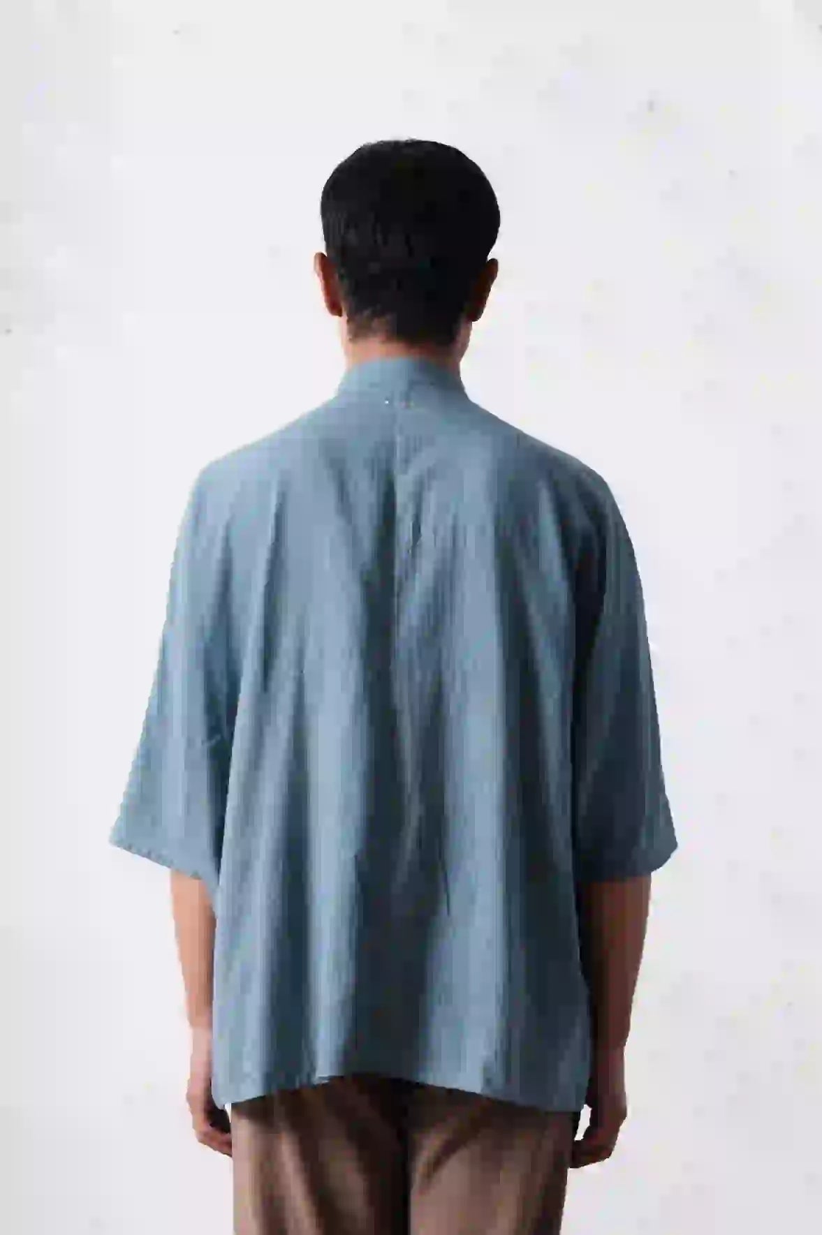 A back shot of man wearing relaxed macca shirt