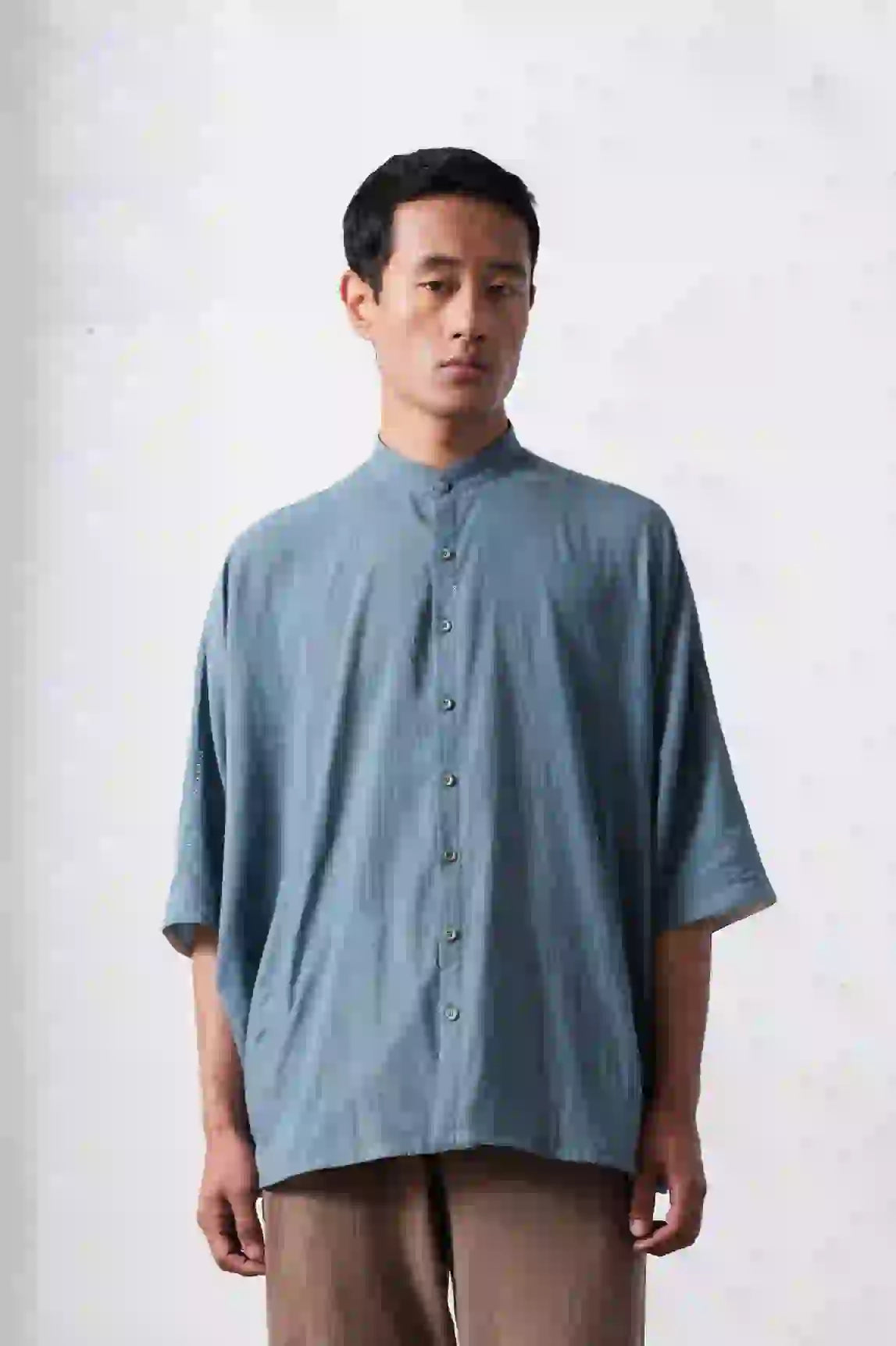 A man wearing powder blue shirt