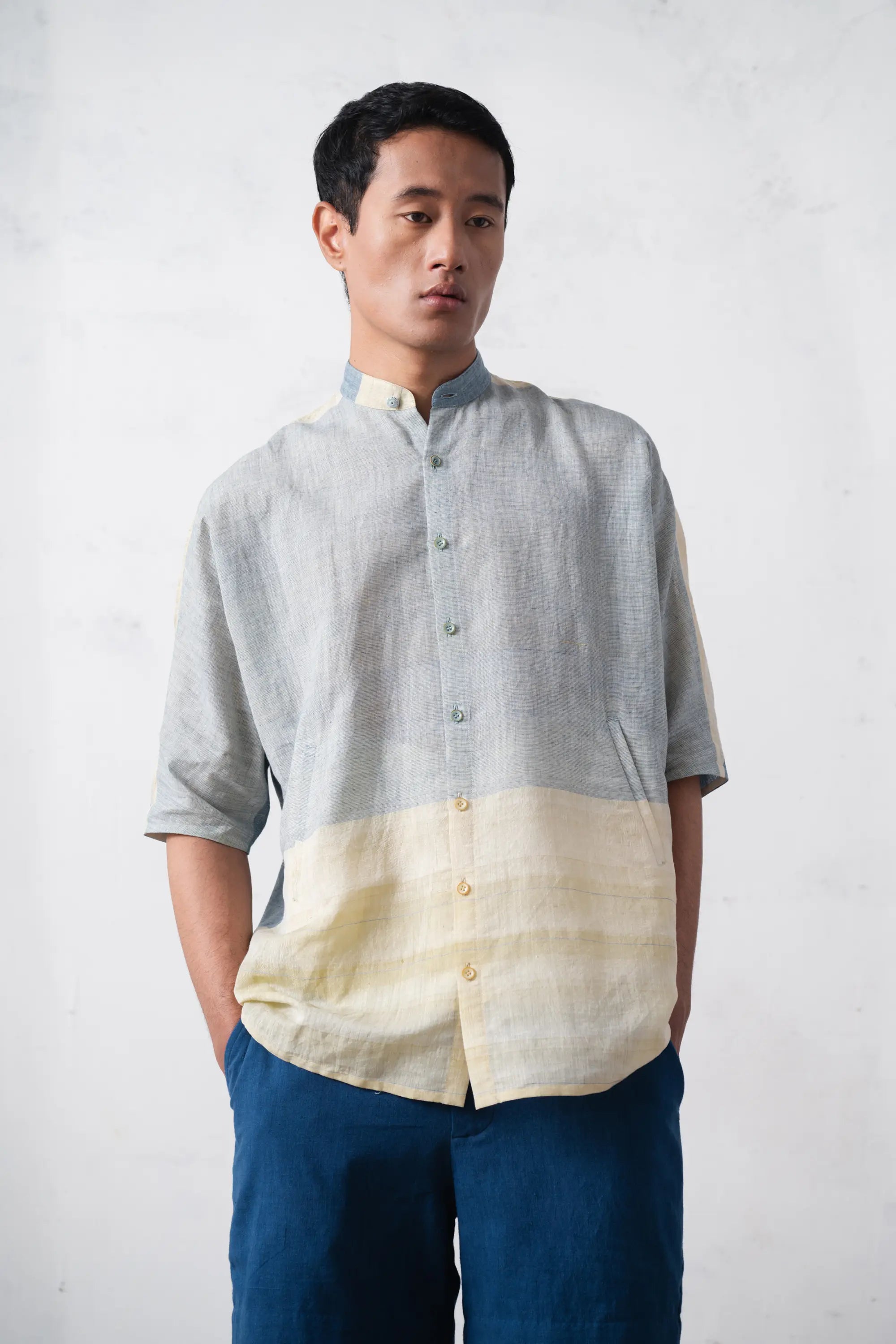 Man wearing a two-tone shirt with a plain background