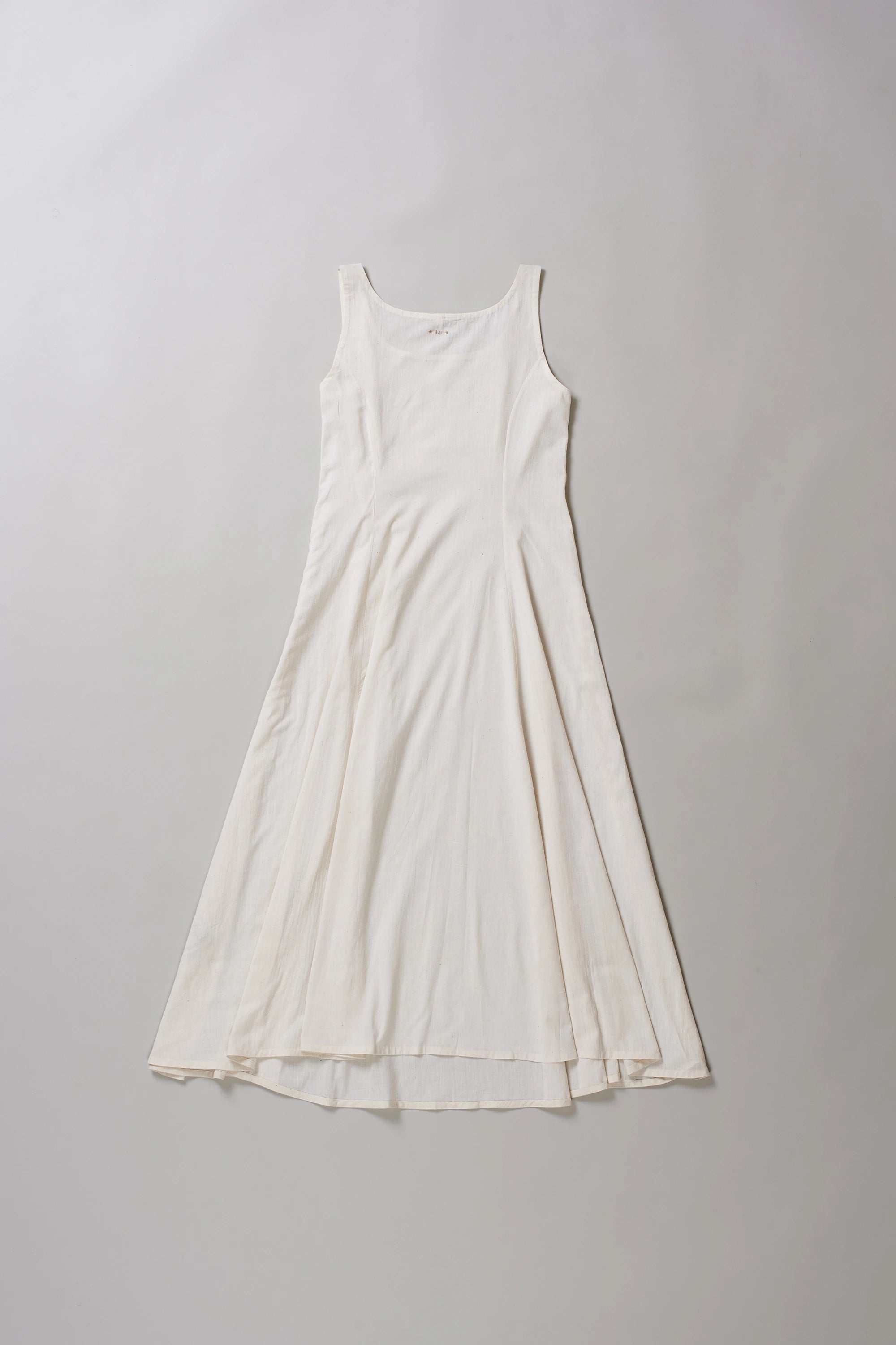 Back image of ecru dress on a grey background
