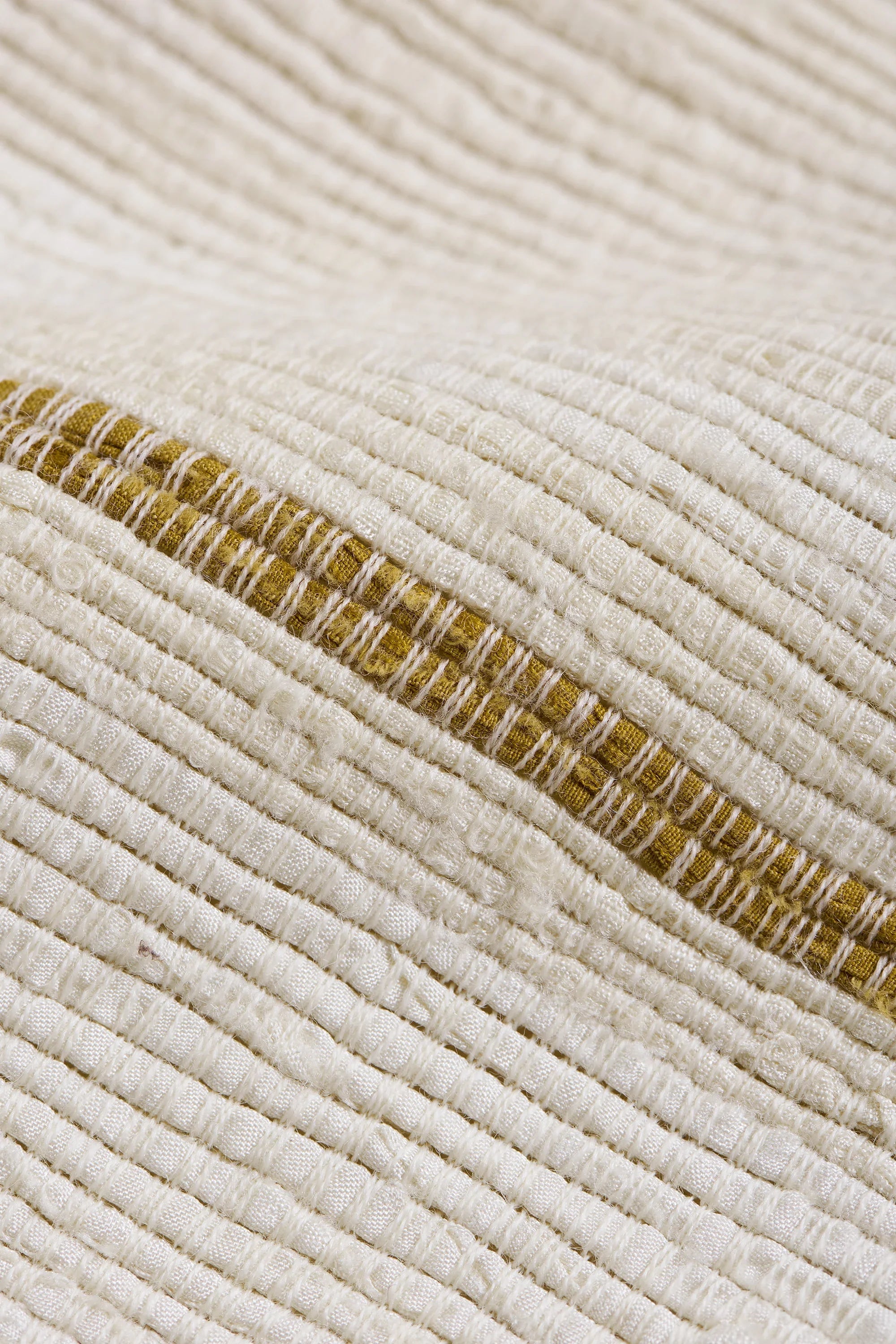 Close-up of a ecru jacket fabric with buttons