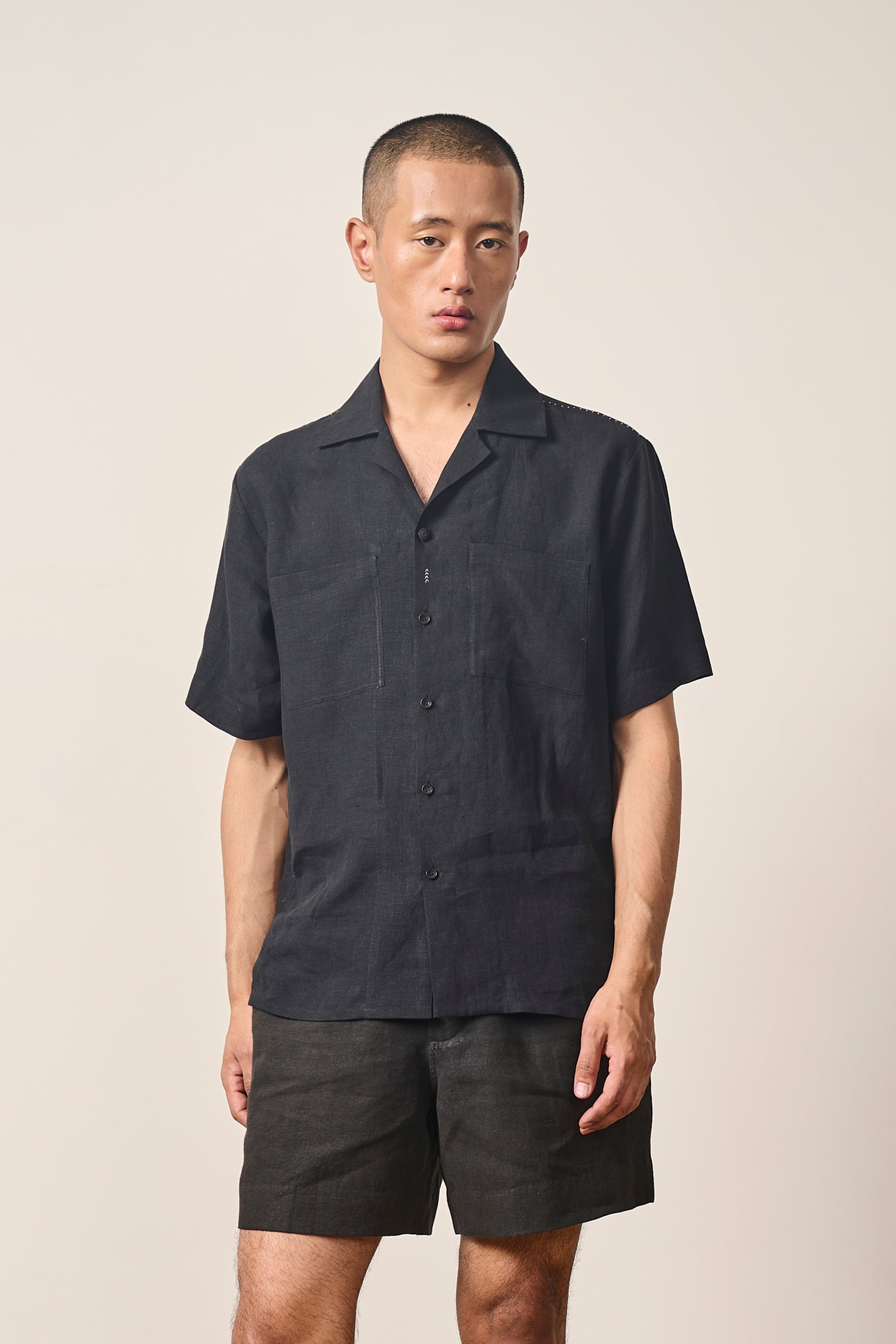 A man wearing black shorts