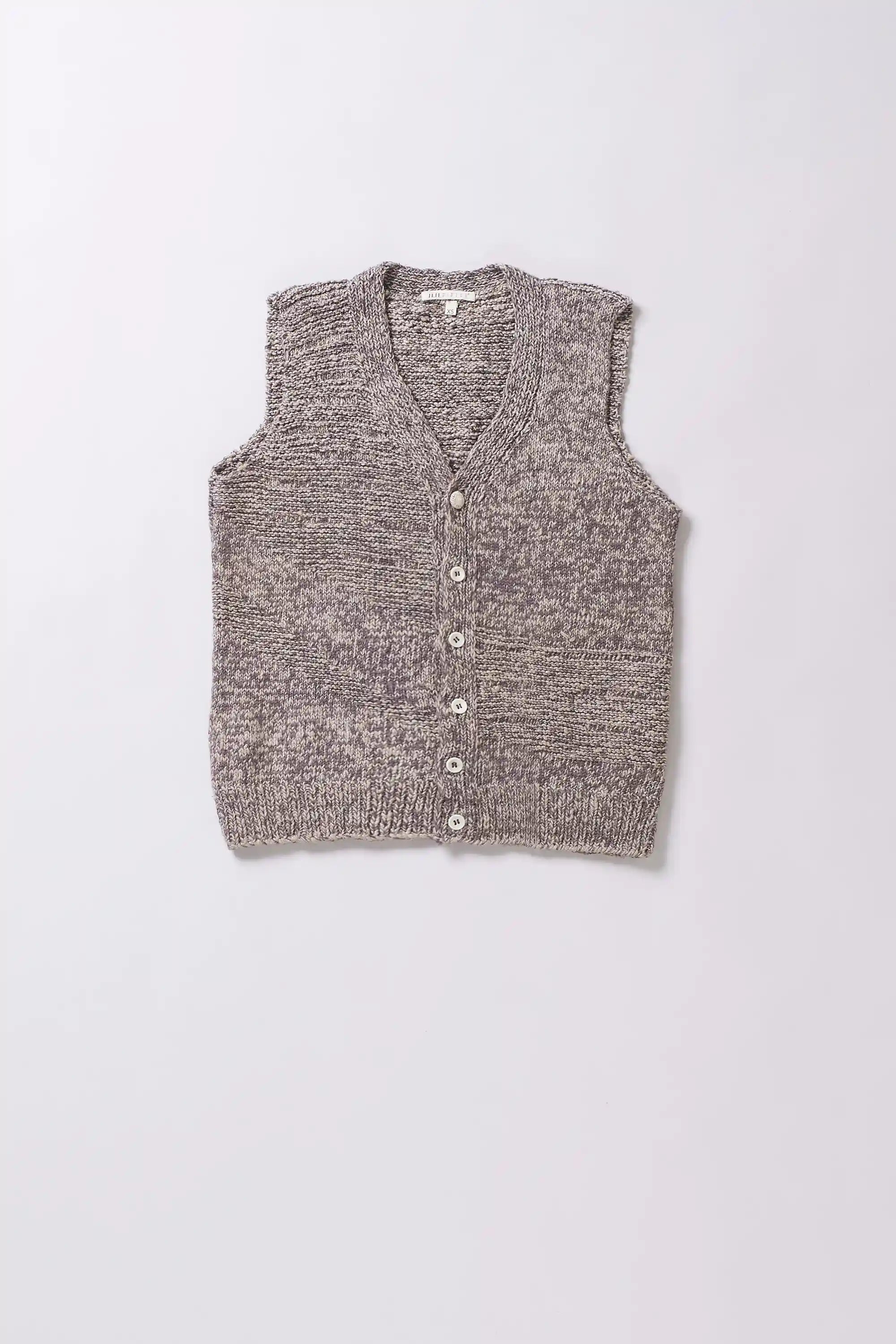 Knitted vest with buttons on a grey background