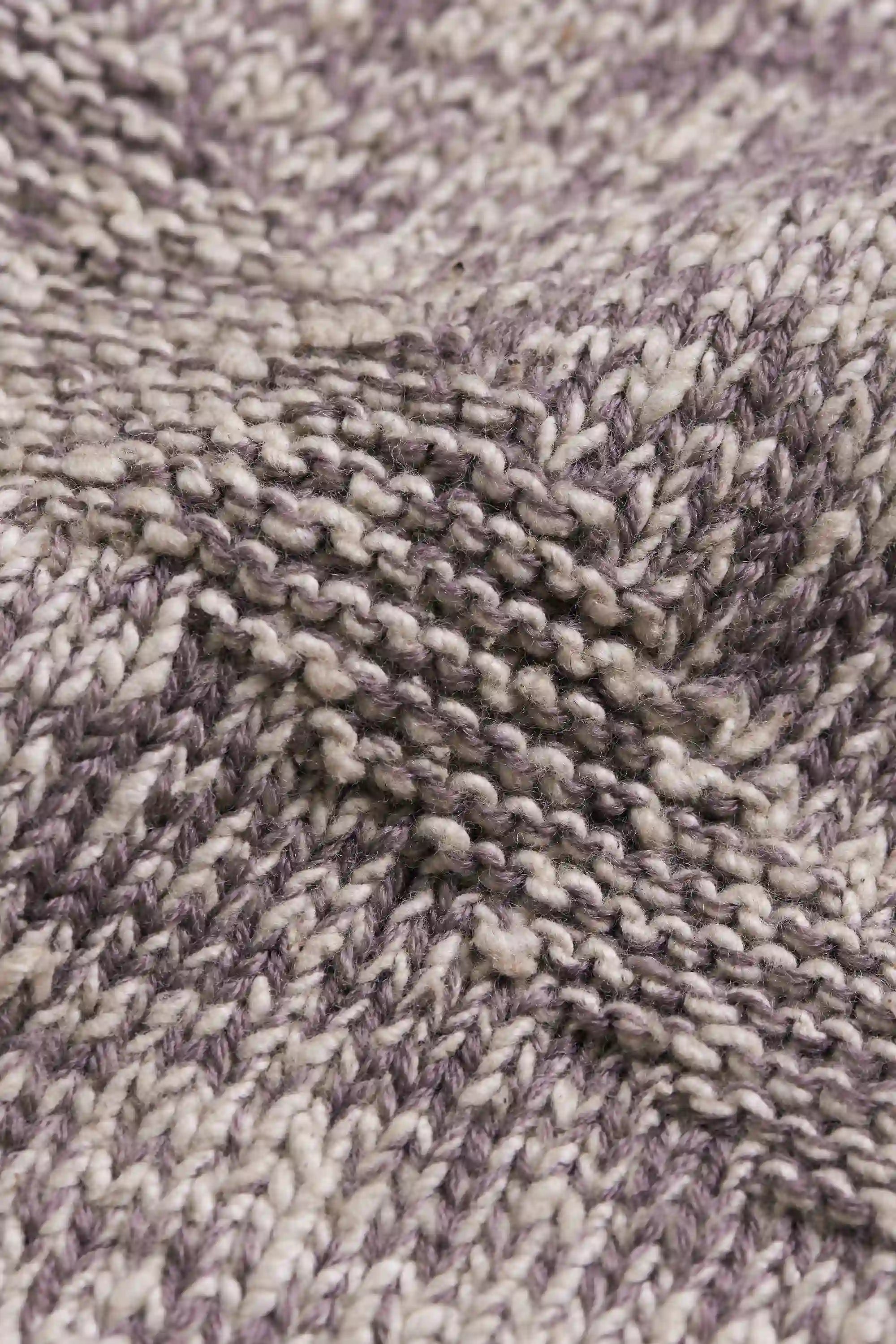 Close-up of a textured fabric with a herringbone pattern