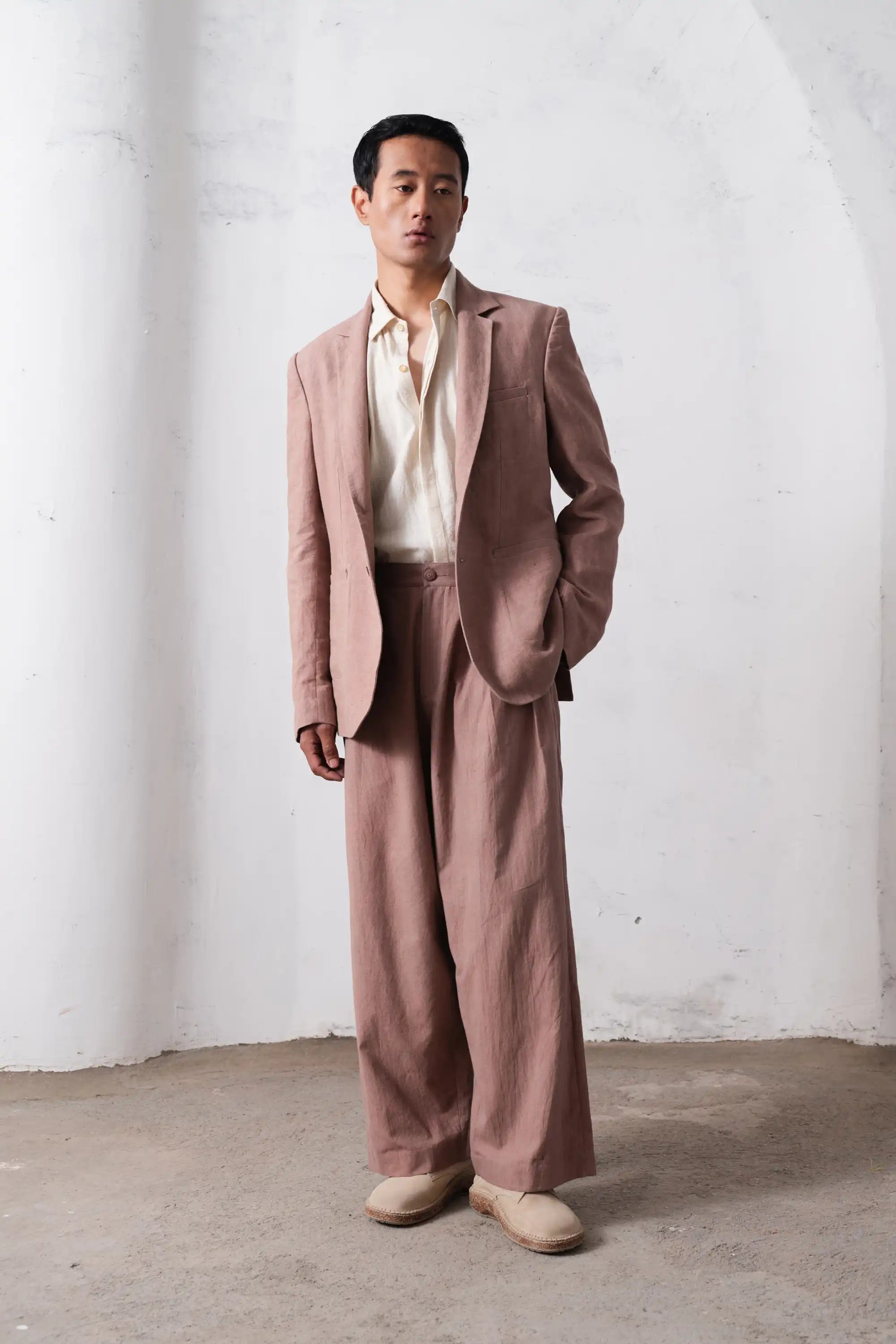 A man wearing old rose jacket