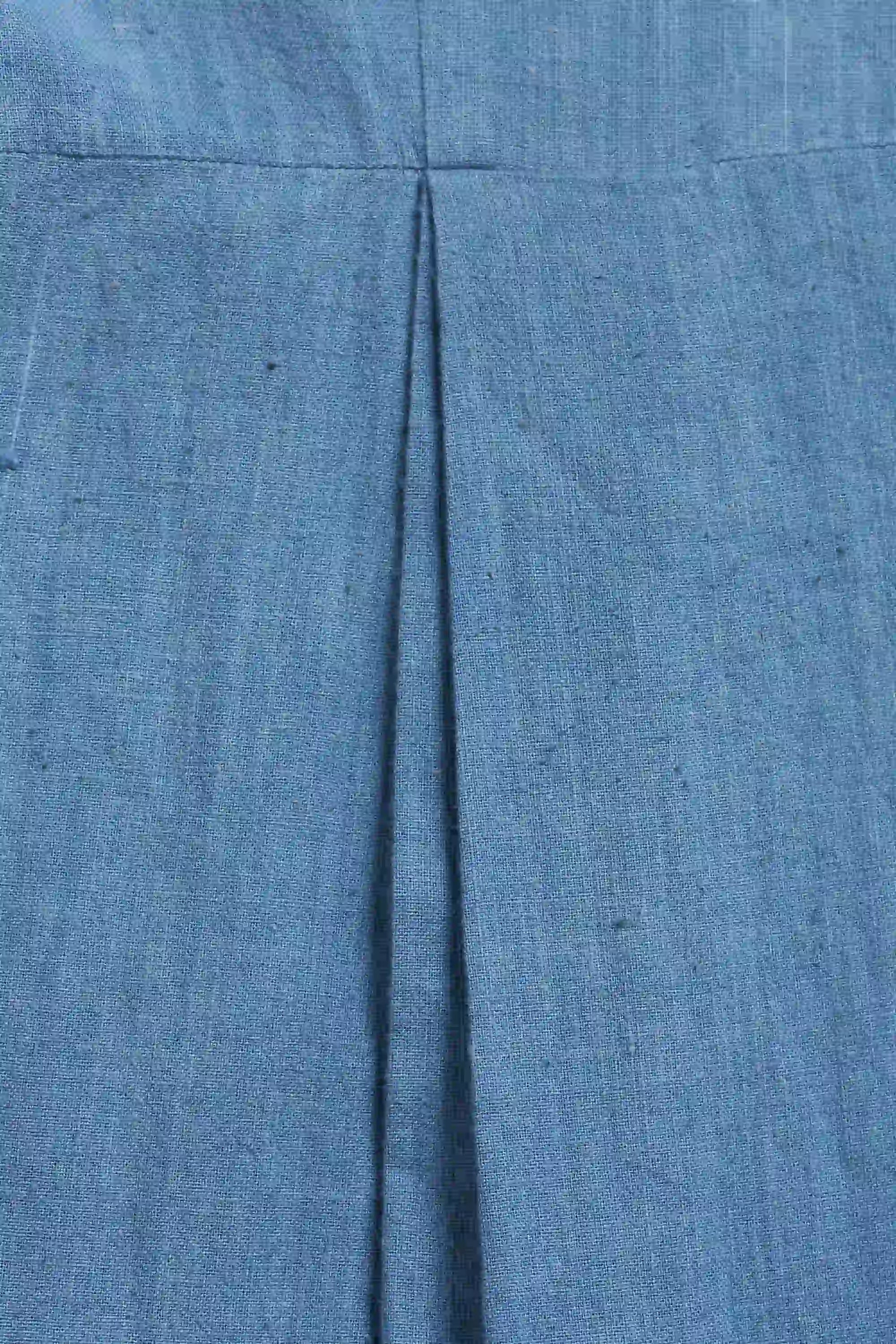 Close-up of blue denim fabric with a visible seam