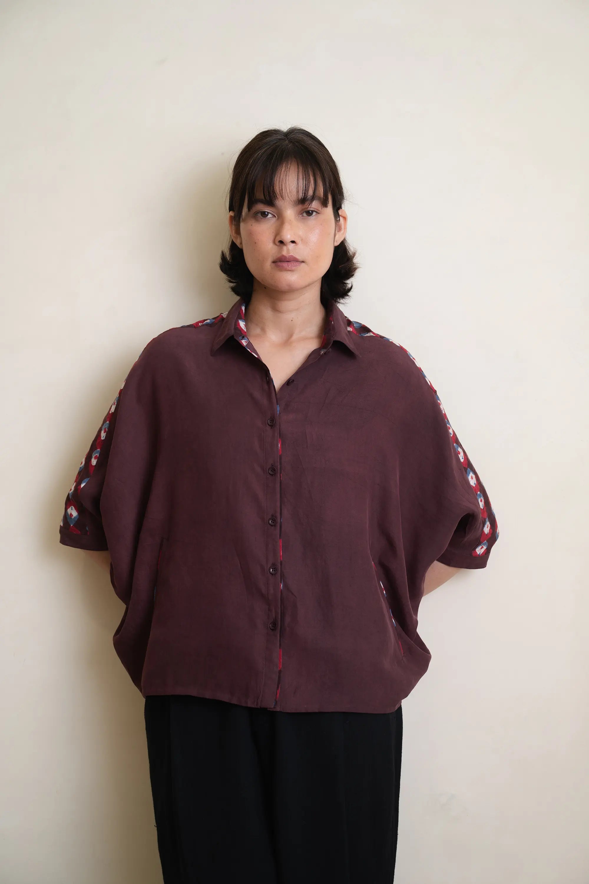 A woman wearing silk purple red shirt