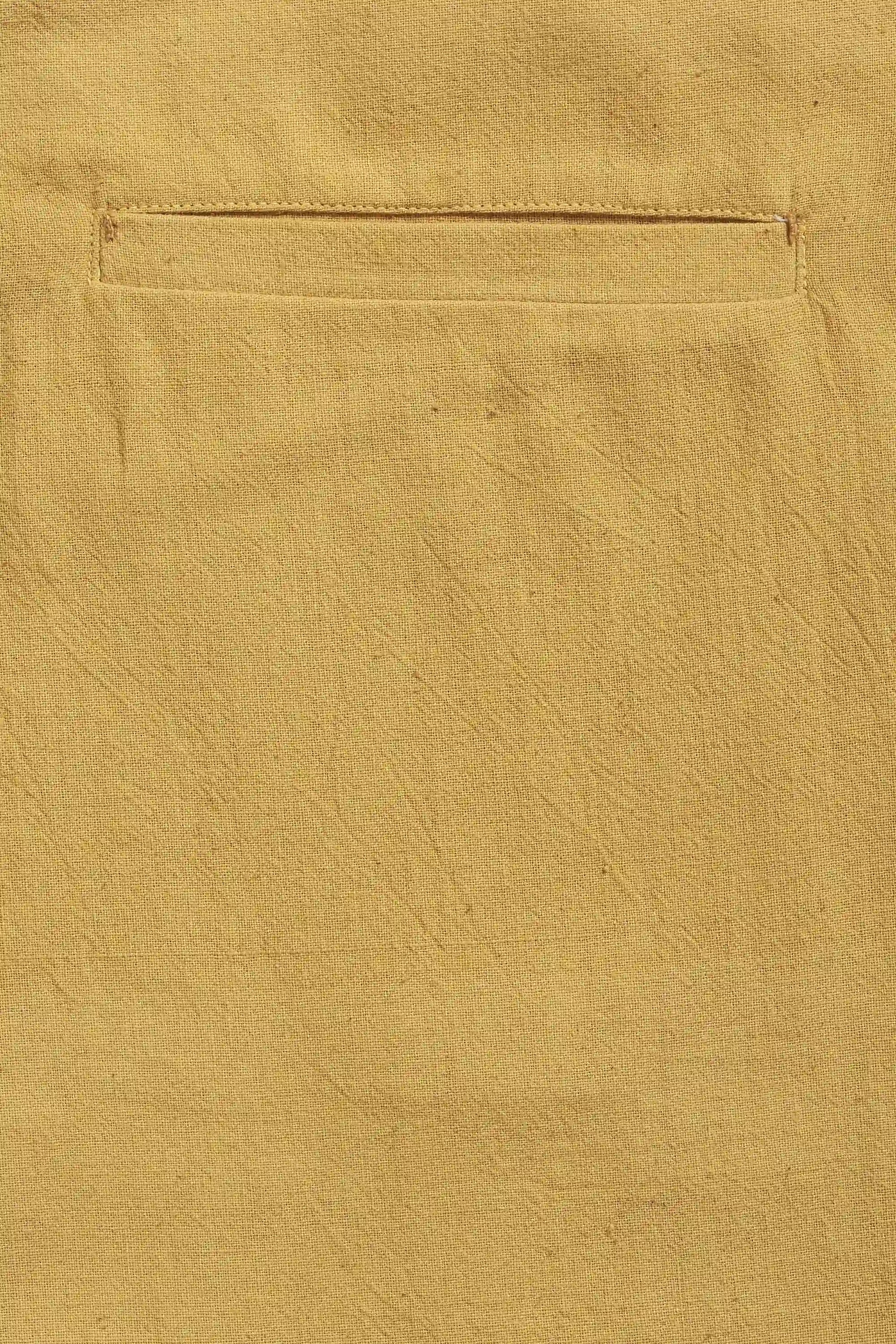 Close-up of a ochre yellow fabric with pocket