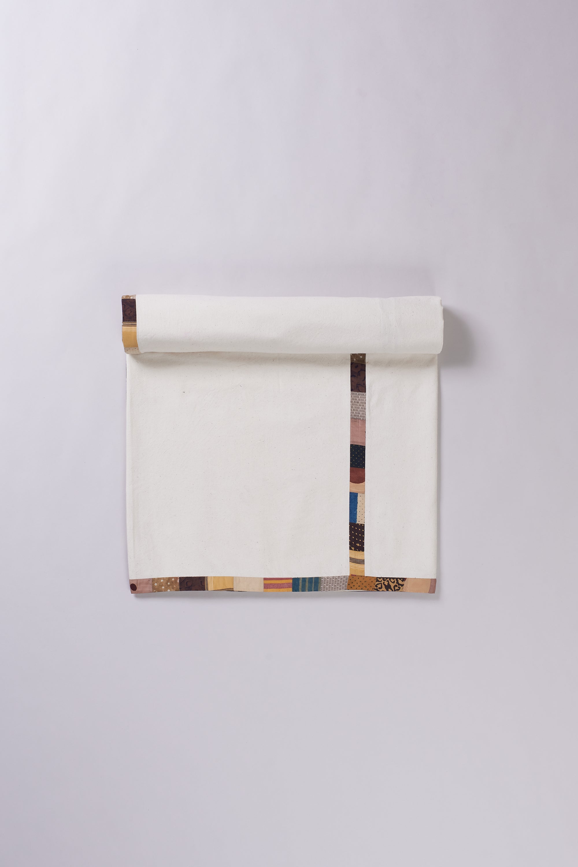 Colorful patterned fabric roll on a white background