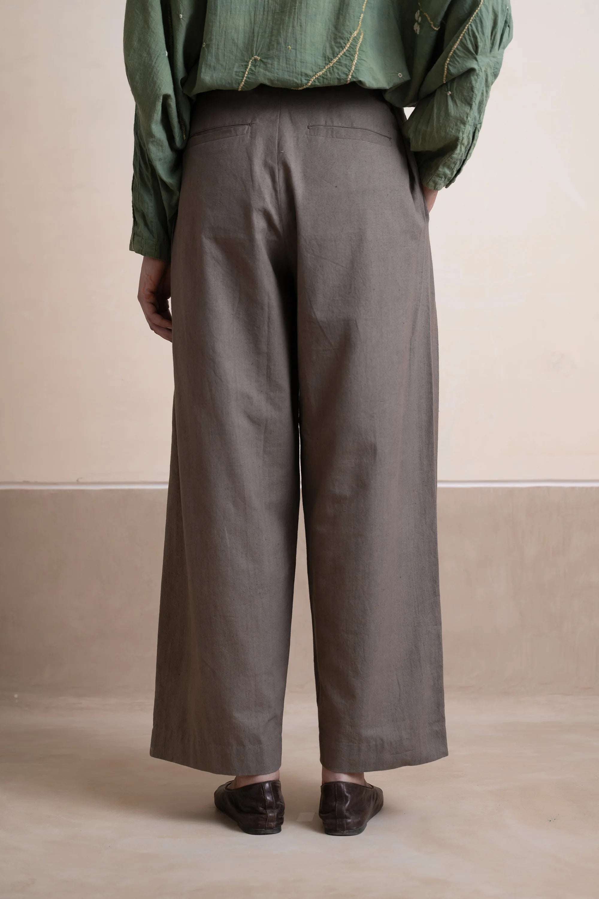 Back shot a woman wearing ash grey cotton pant