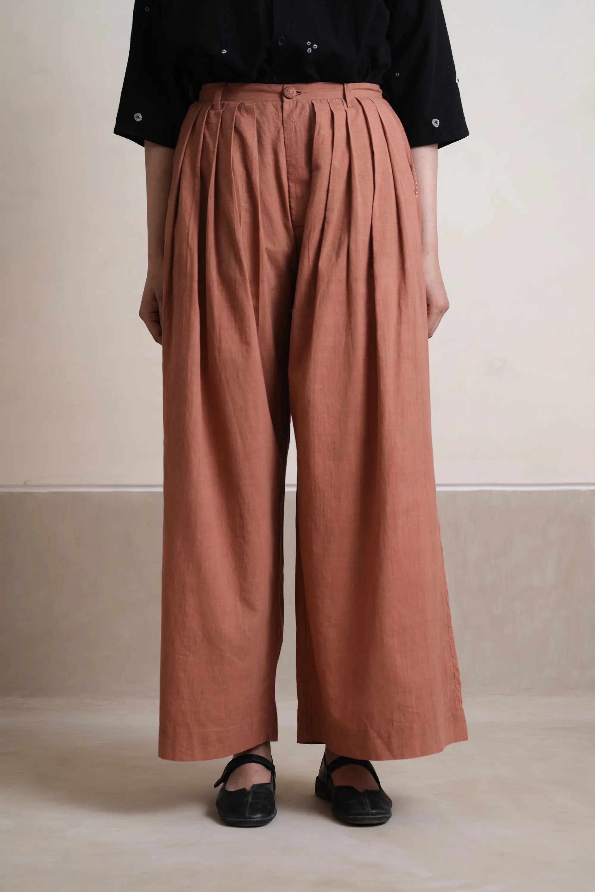 A woman wearing orange rust pant