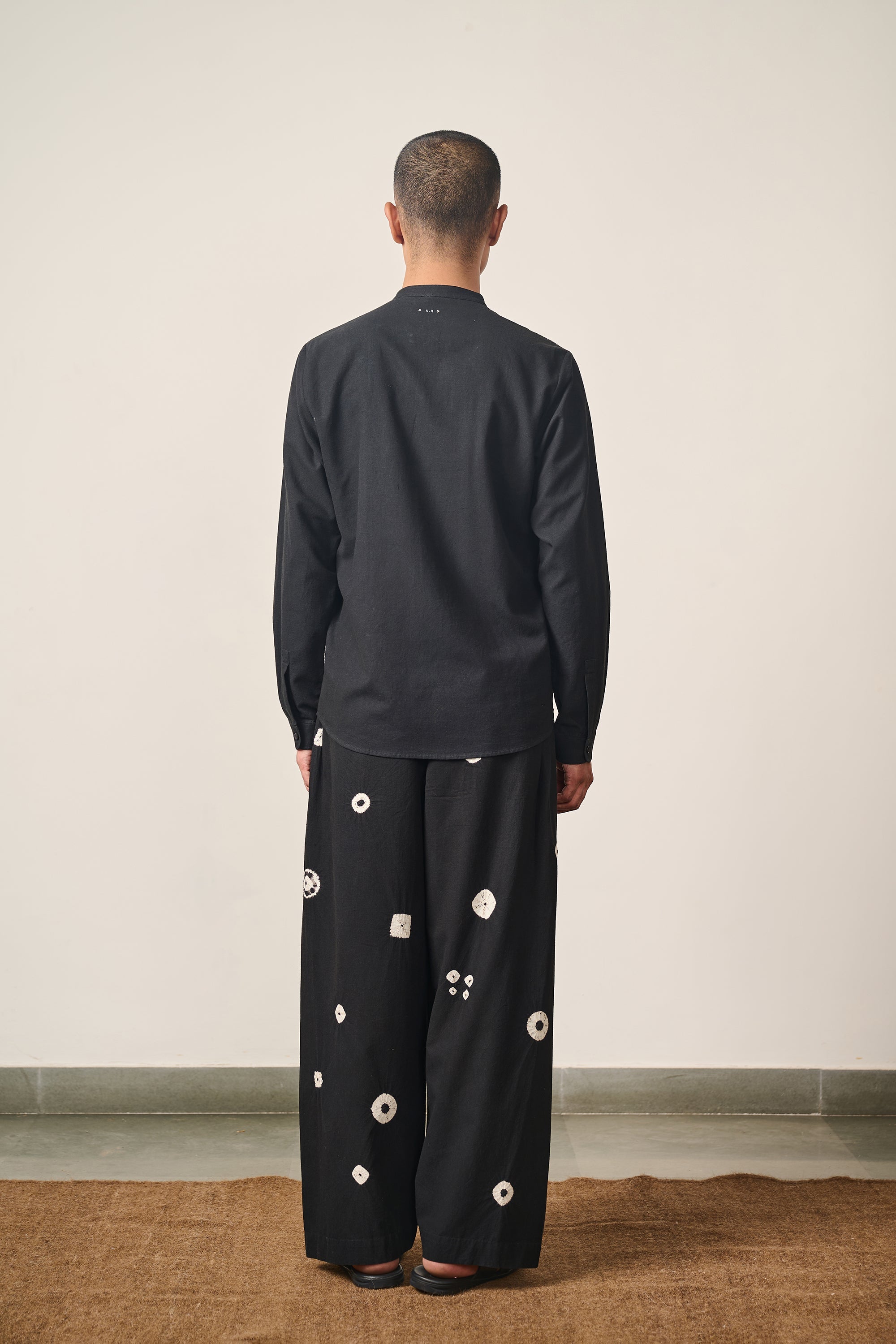 A back shot of a man wearing black shirt