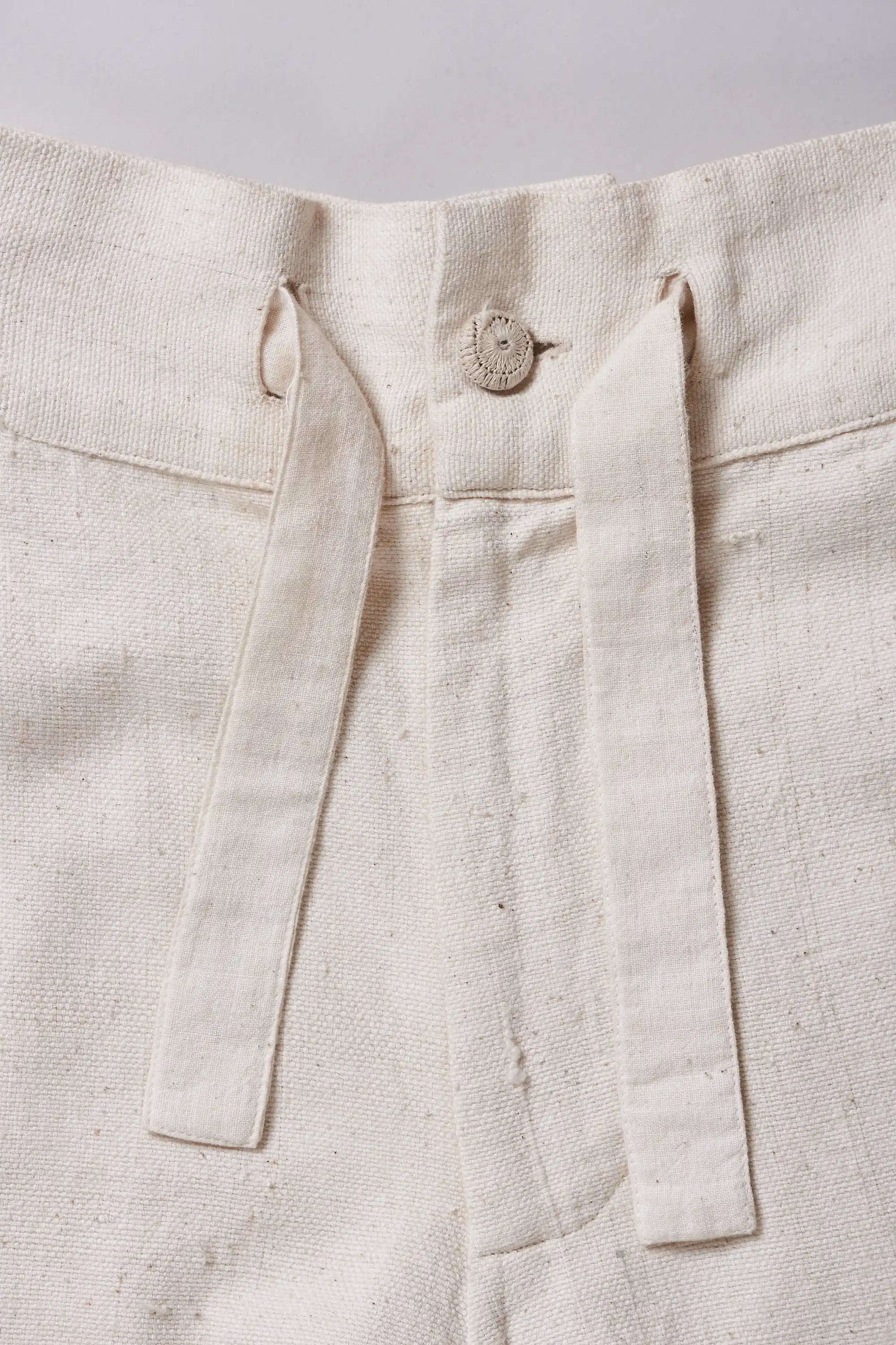 Close-up of fabric with button and strips
