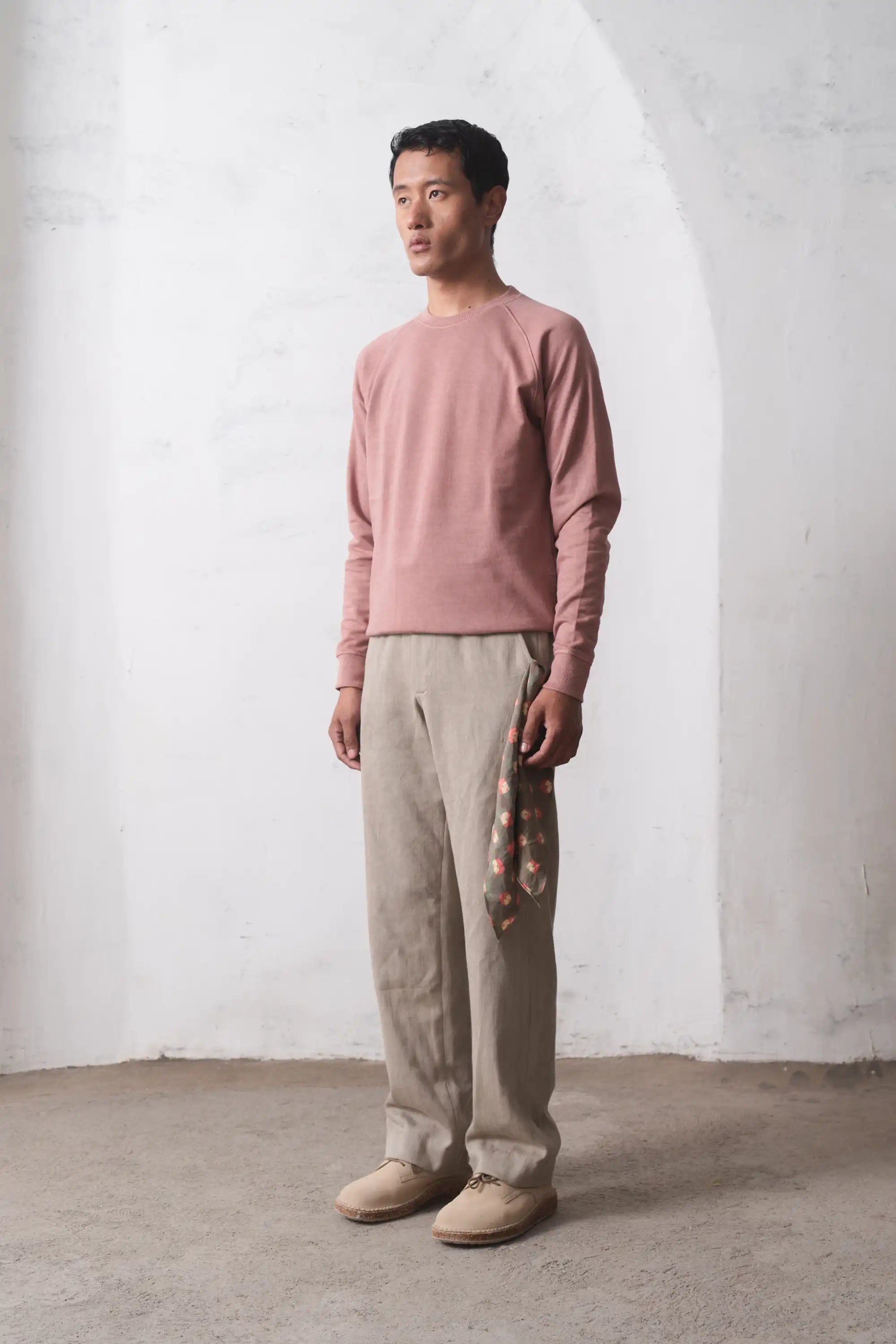 A man wearing old rose sweatshirt