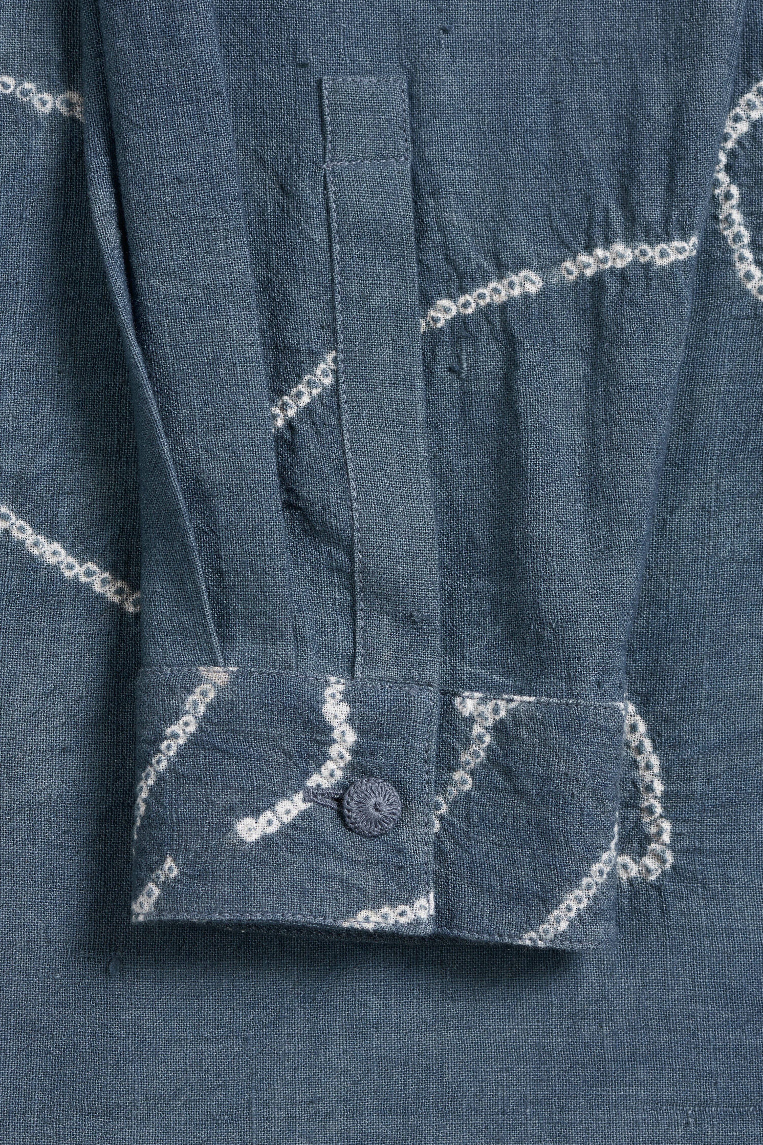 Close-up of a ash indigo fabric with bandhani