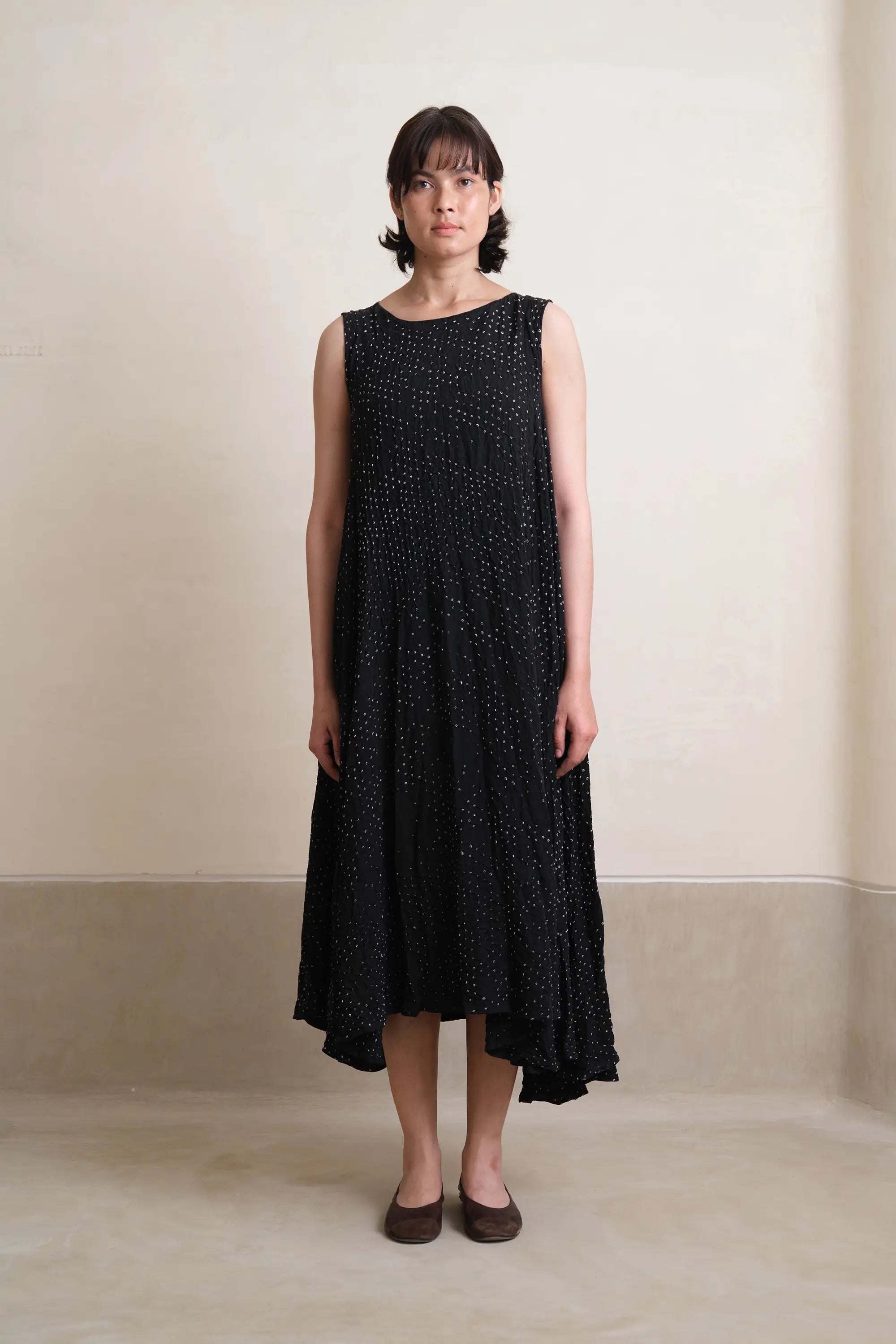 A woman wearing black silk dress