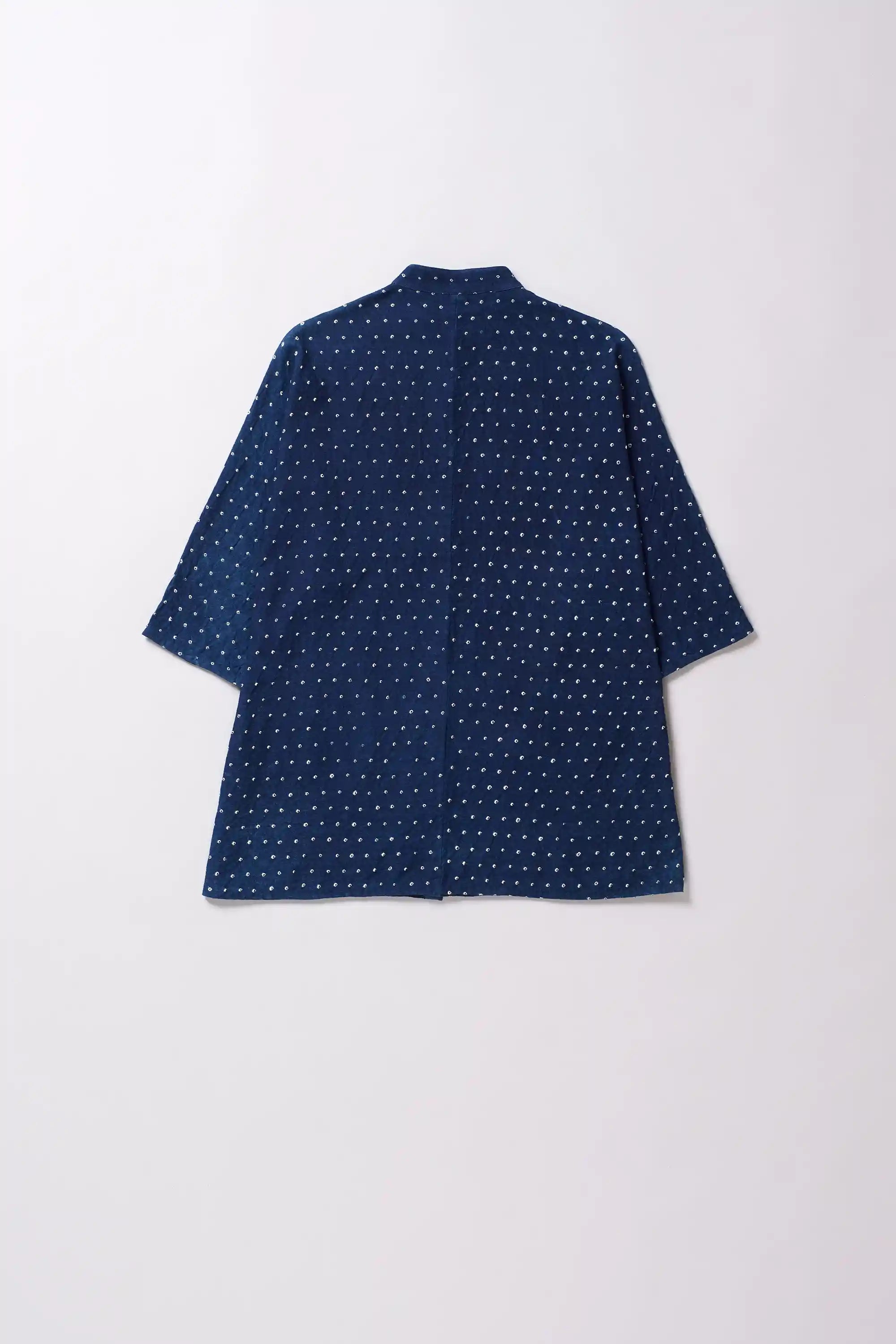 Blue bandhani shirt on a light grey background