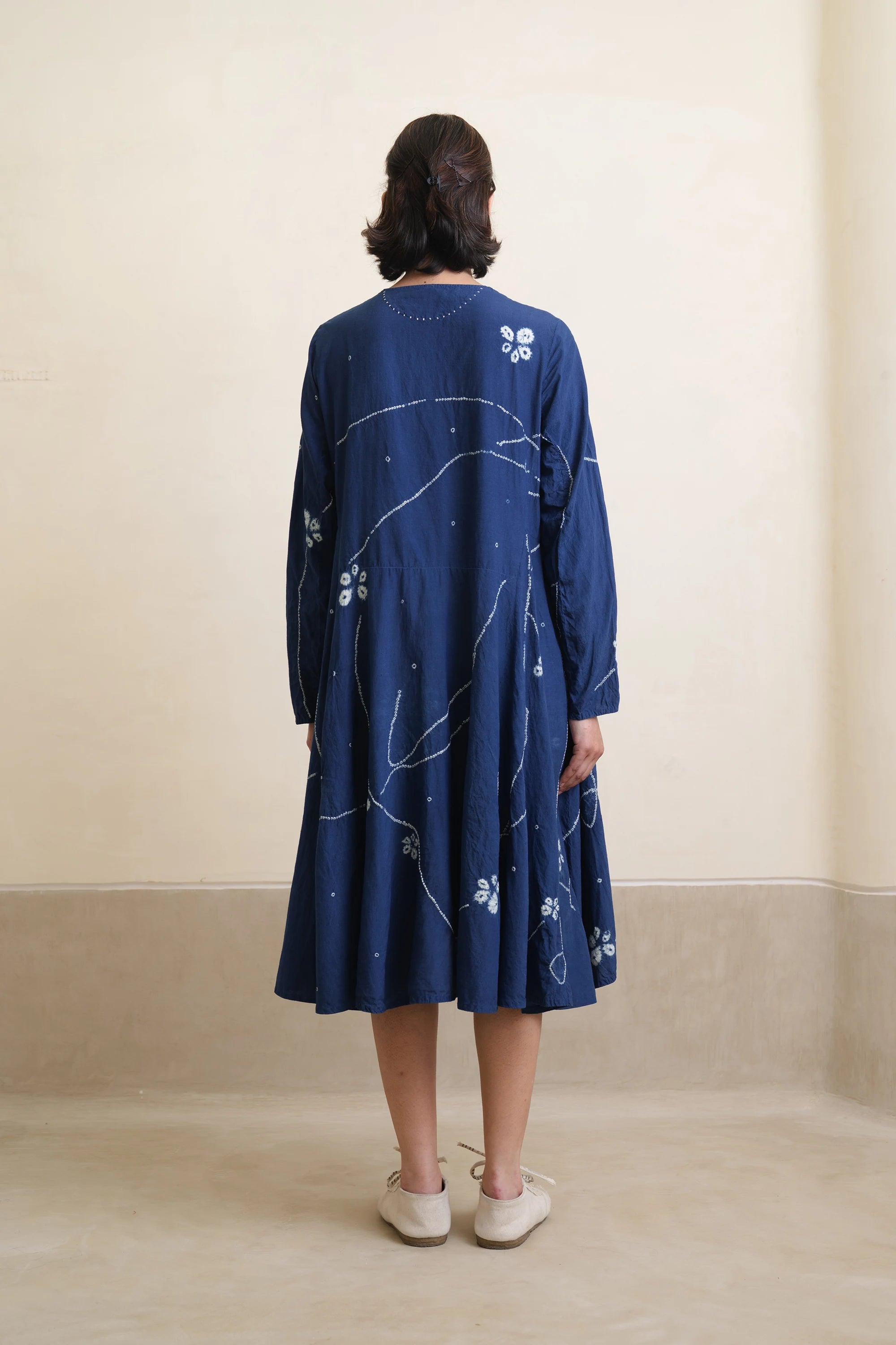 Back shot of woman model wearing indigo shibori dress