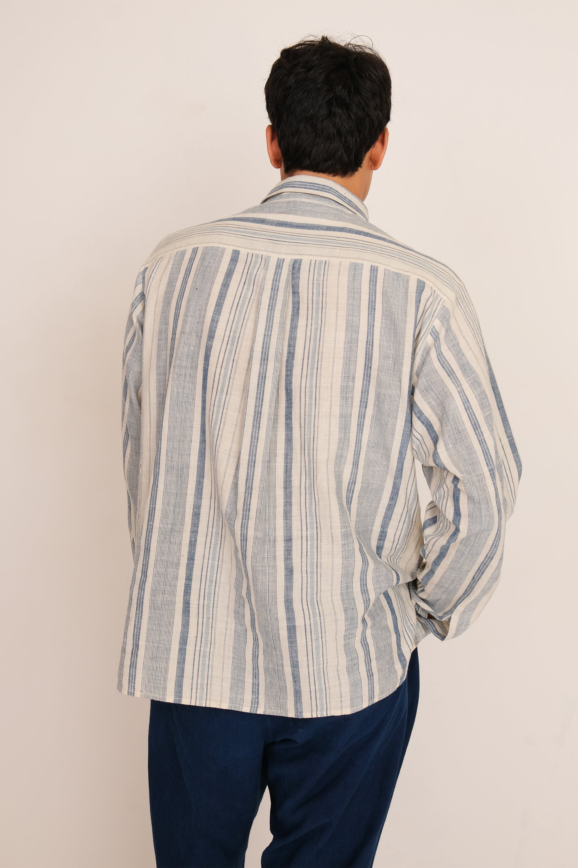 Back shot a man wearing medium indigo yarn dyed shirt
