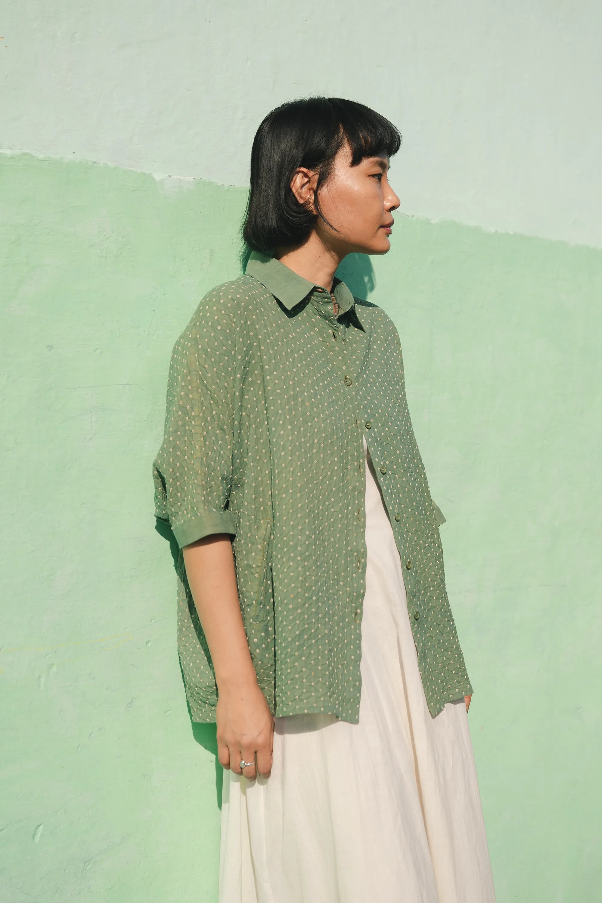 A women wearing turf green cotton shirt