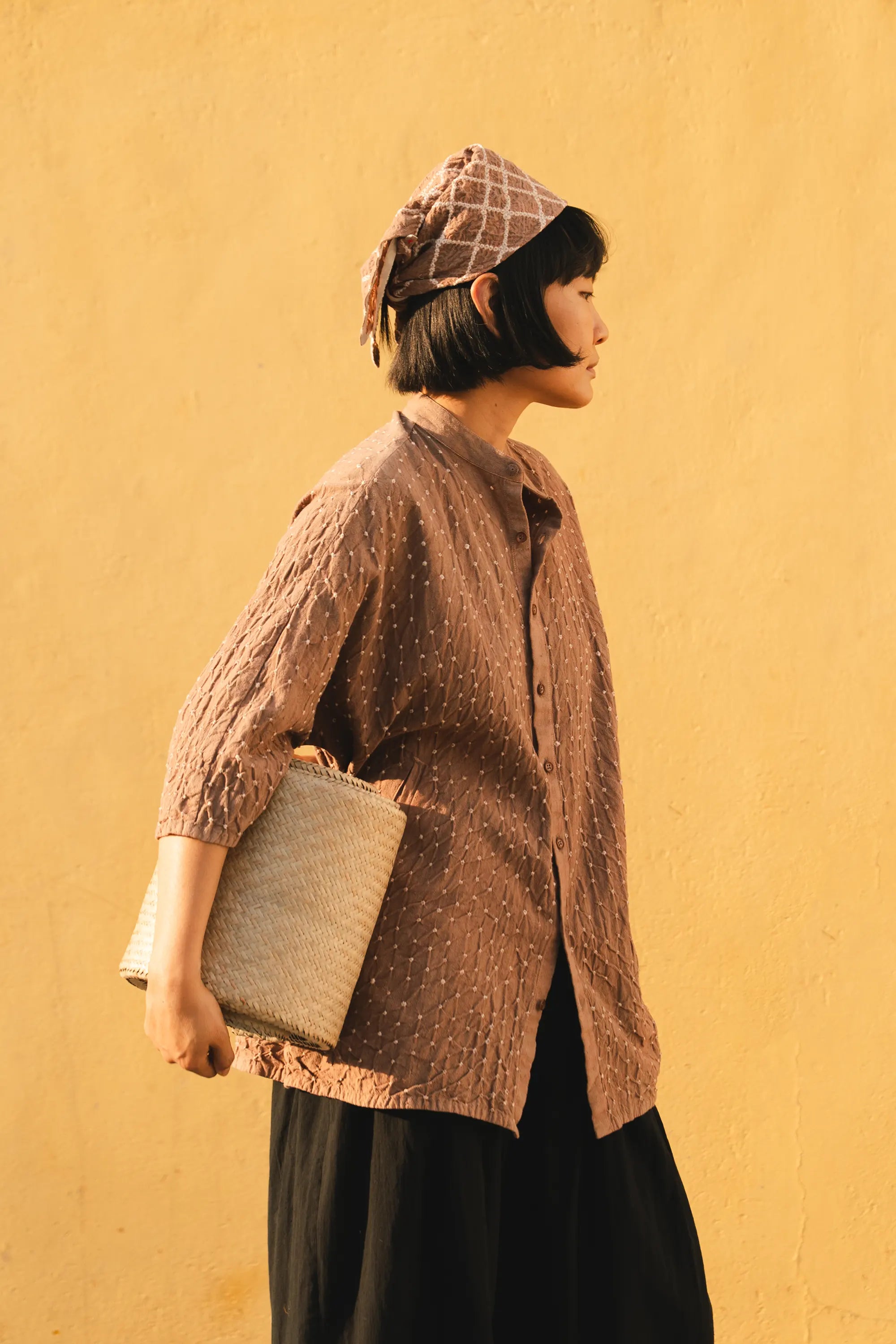 A side shot of a women wearing old rose cotton shirt